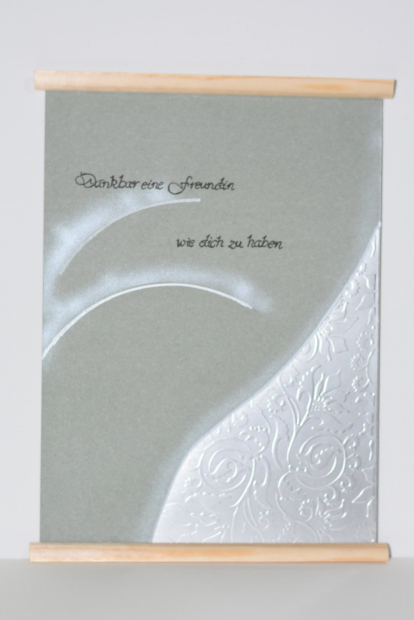 a greeting card with a white background and a silver foiled card