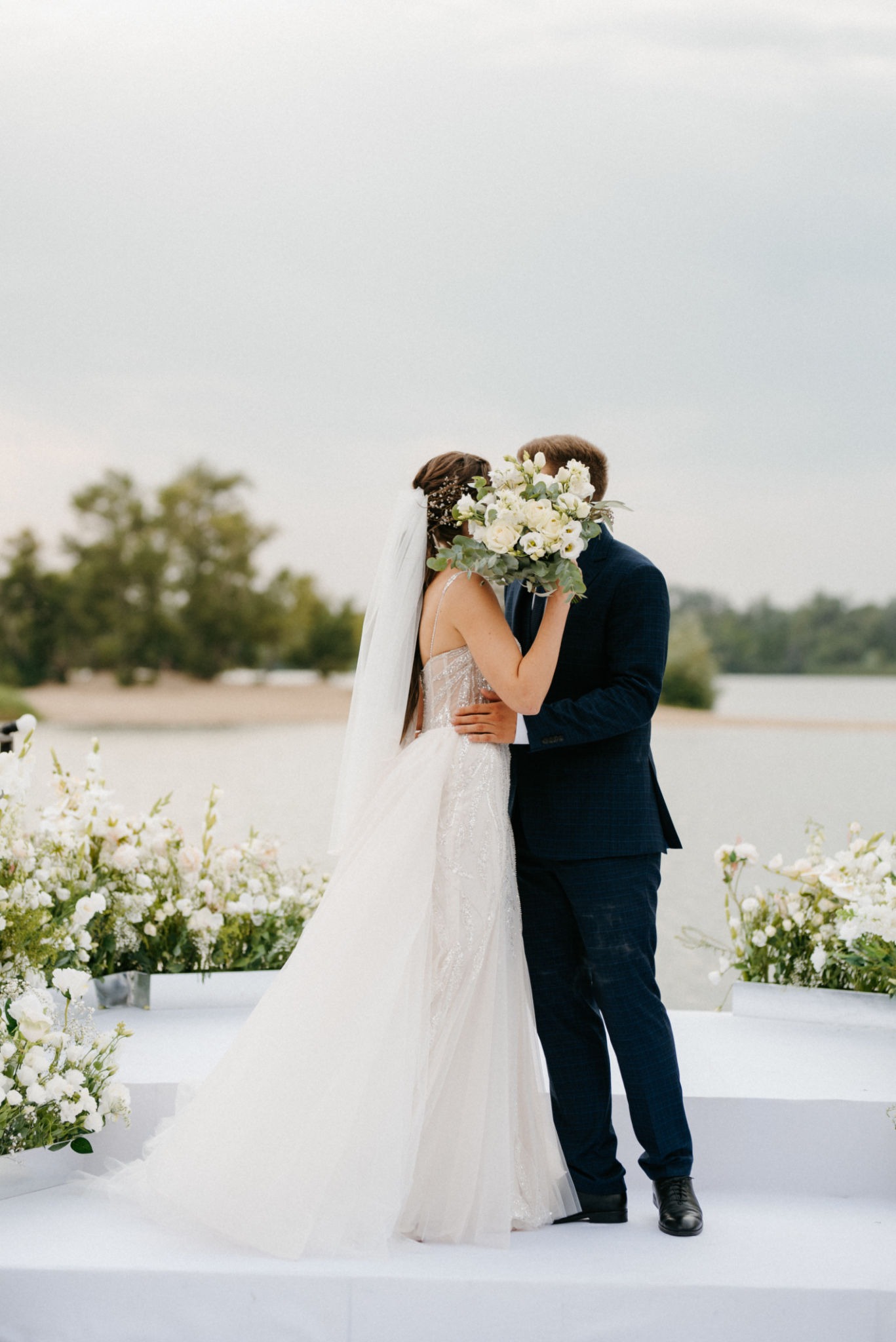 Bride and groom kiss at outdoor ceremony captured by professional wedding videographer in Glasgow