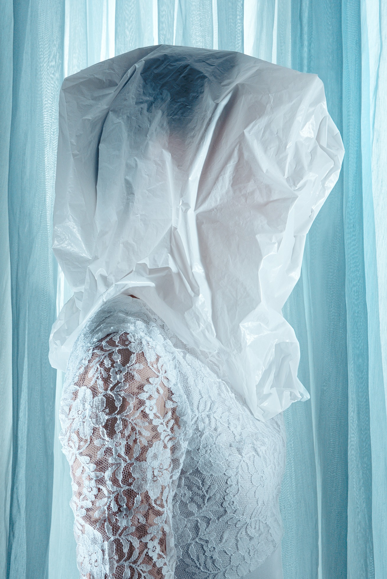 a woman in a white dress with a veil on her head