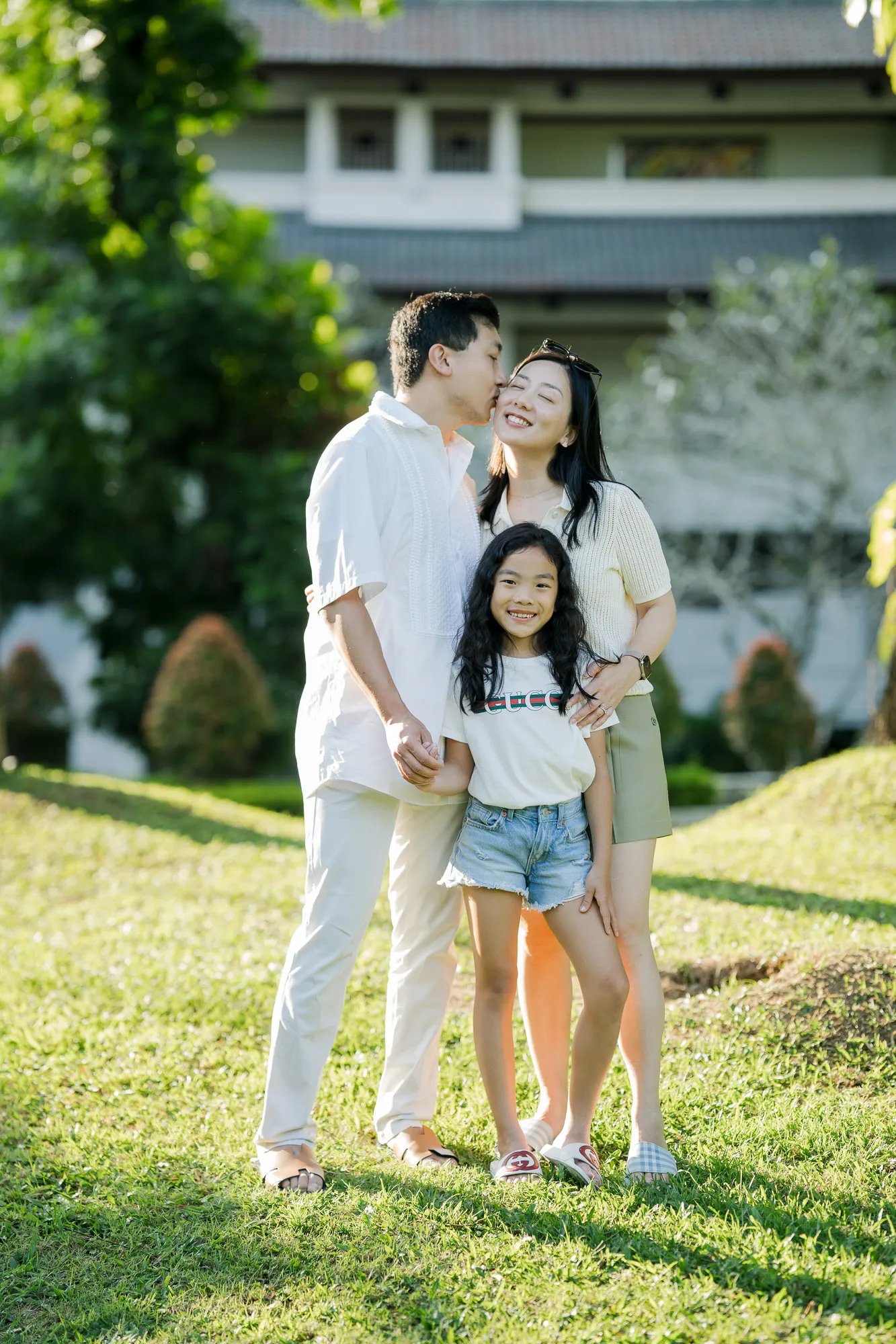 Family portrait in the tropical gardens of InterContinental Bali Resort during golden hour