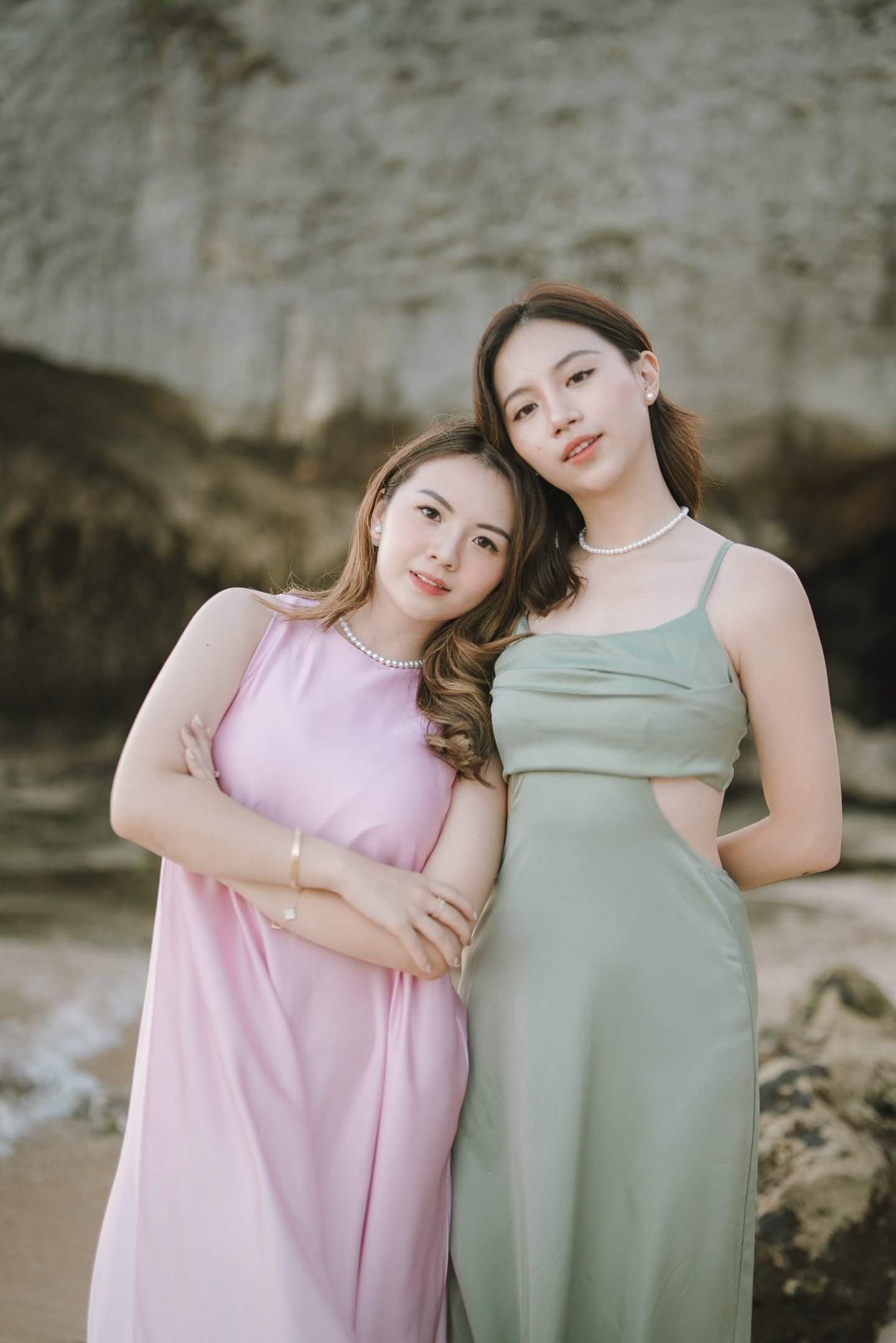 Portrait of two friends posing together near cliff during photoshoot at Geger Beach Nusa Dua Bali