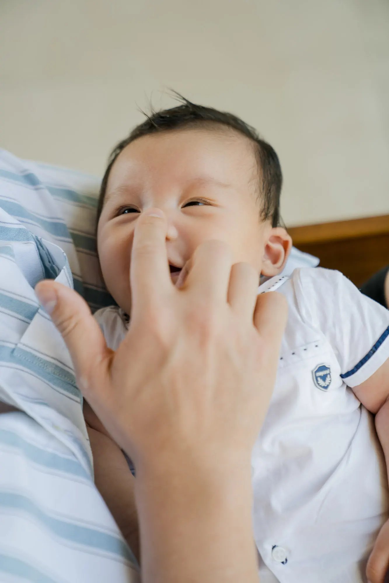 Close-up portrait of a smiling baby at Samabe Bali Suites & Villas in Nusa Dua.
