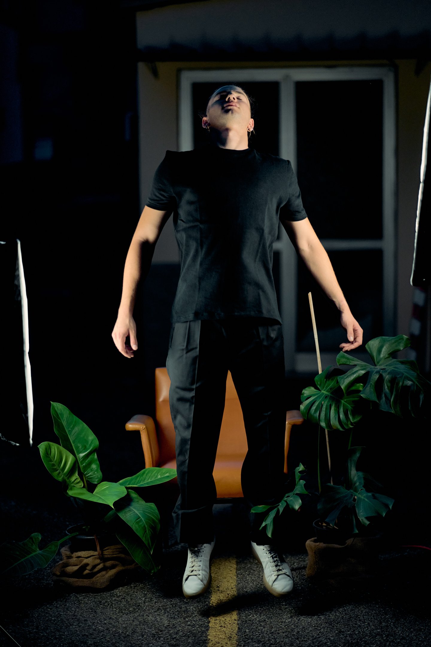a man in a black shirt and white sneakers