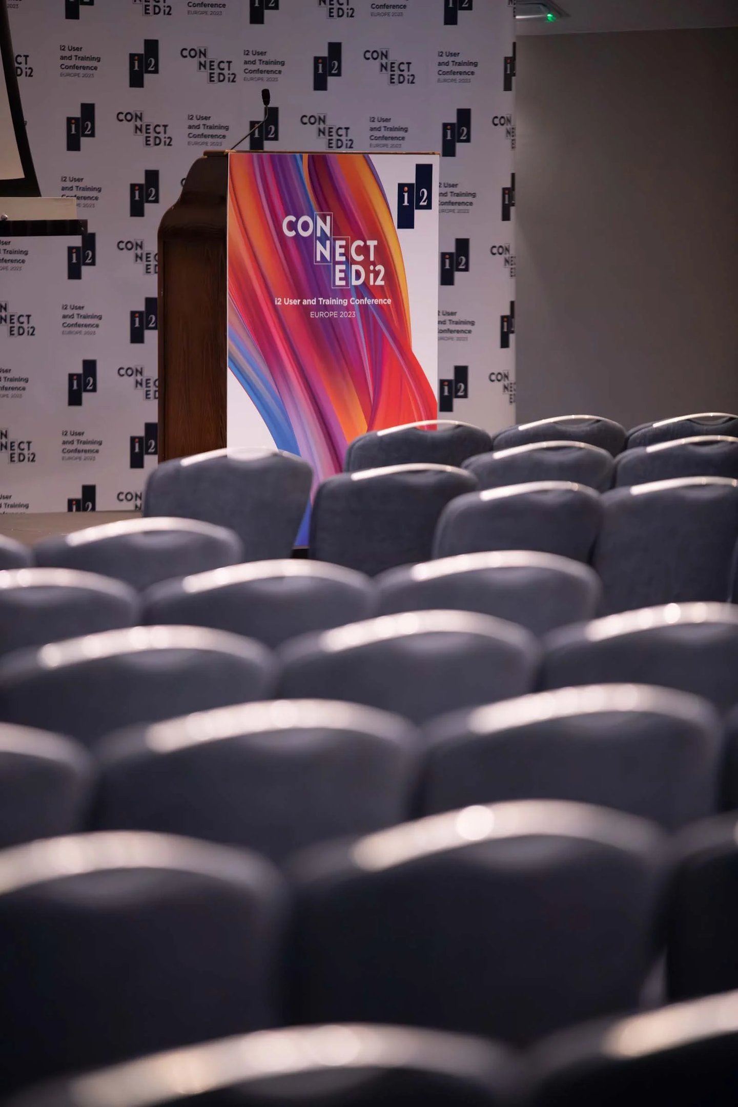 Podium and rows of empty chairs at the i2 User and Training Conference Europe 2023.