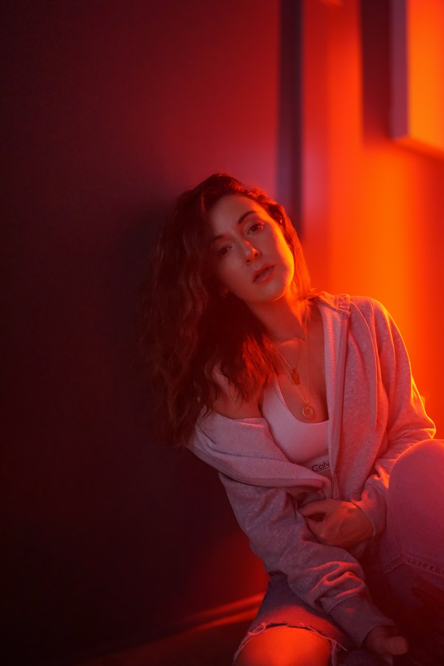 a woman sitting on a bench in a room