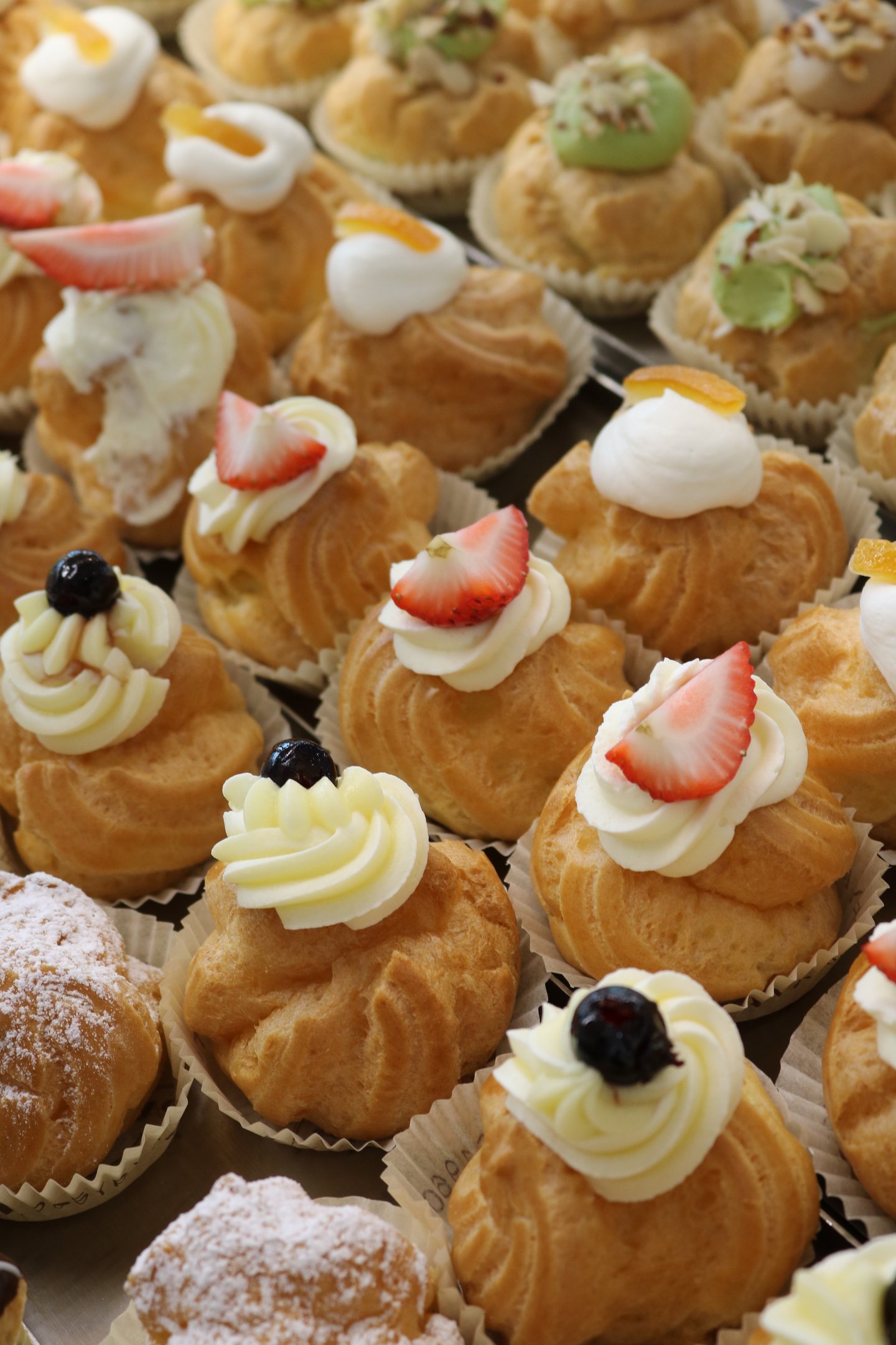 a variety of pastries on display in a bakery