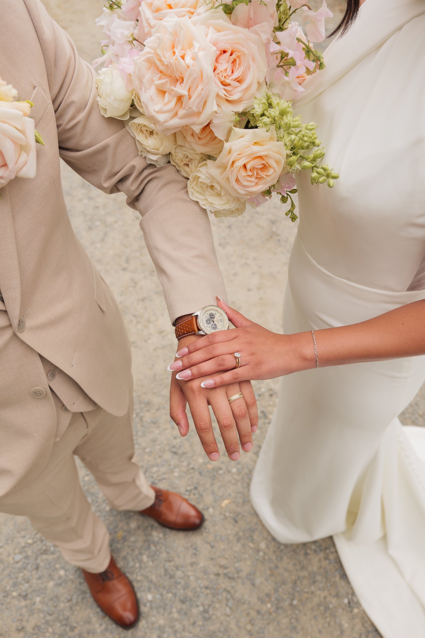 a bride and groom holding hands with a ring
