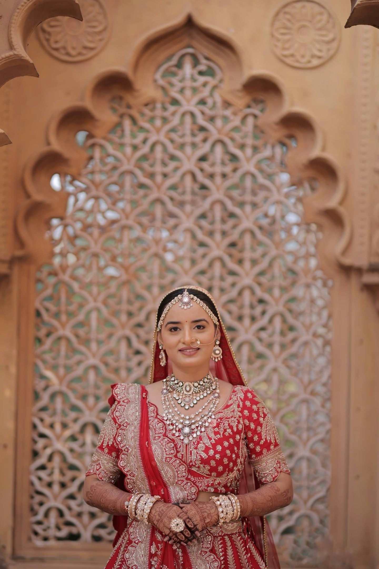 Royal red bridal makeup look with traditional jewellery by Vadodara makeup artist