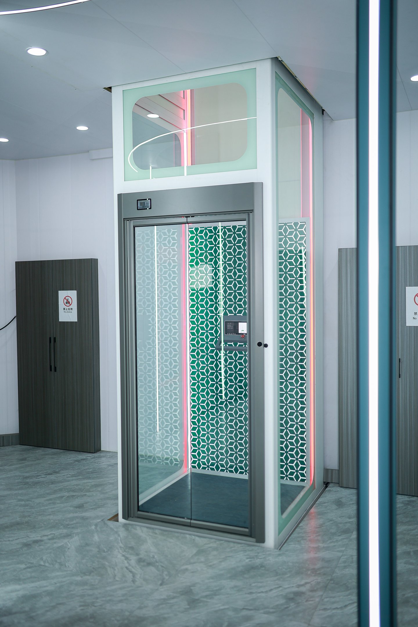 Modern luxury home elevator with glass walls and decorative interior LED lighting.