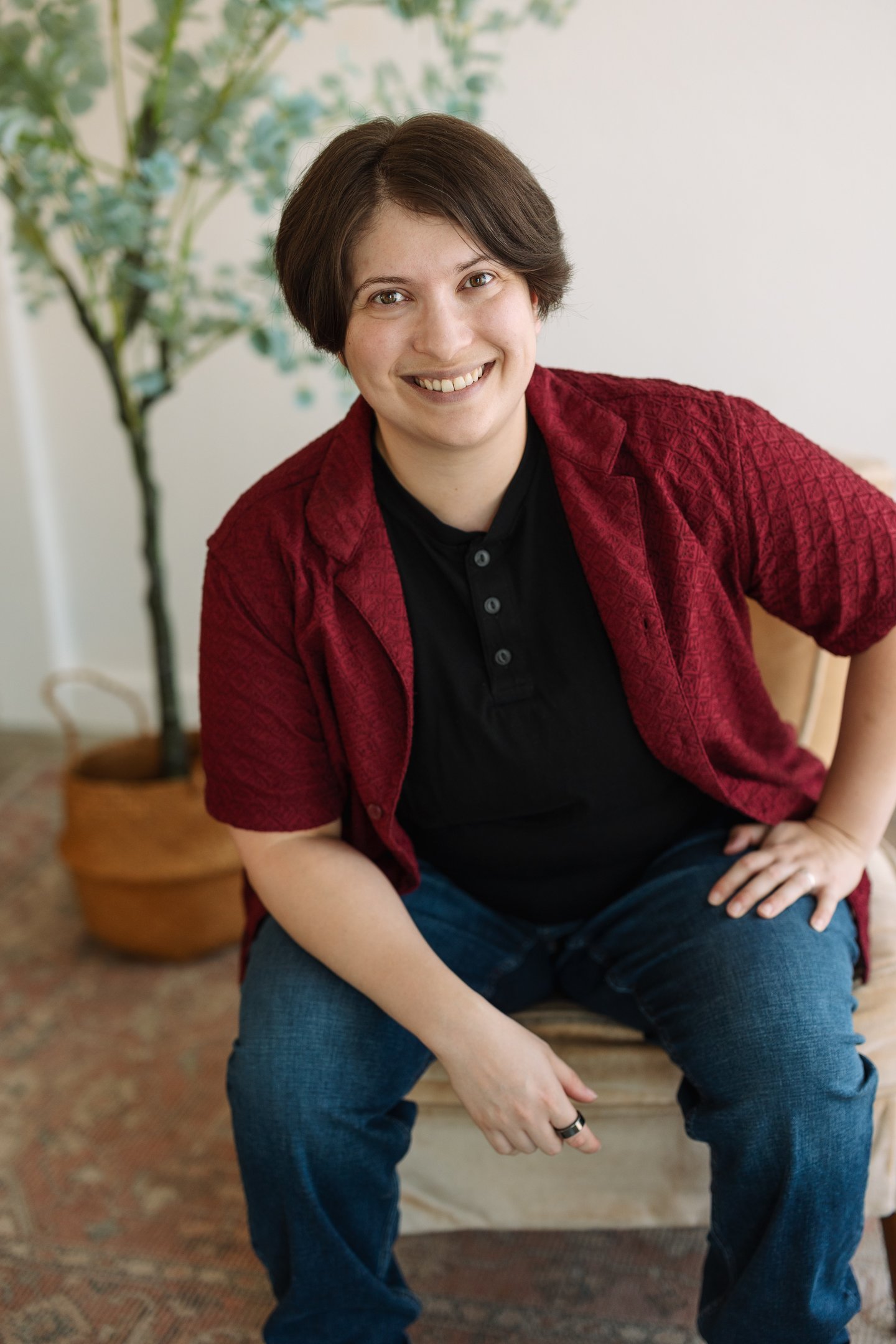 Photo of Rashad McAllister wearing a black and a red shirt and smiling warmly at the viewer