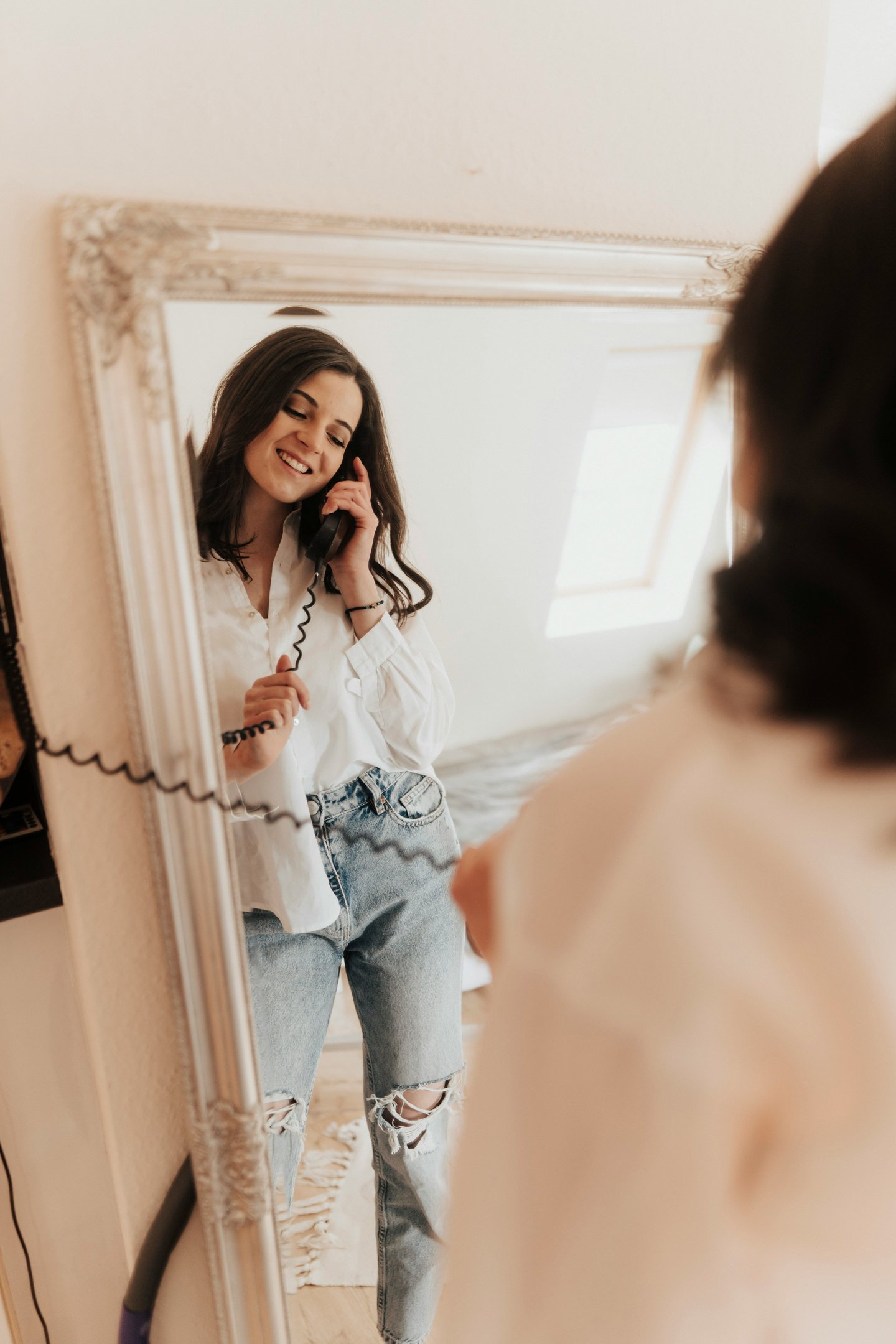 confident woman smiling getting ready for a first date looking in the mirror