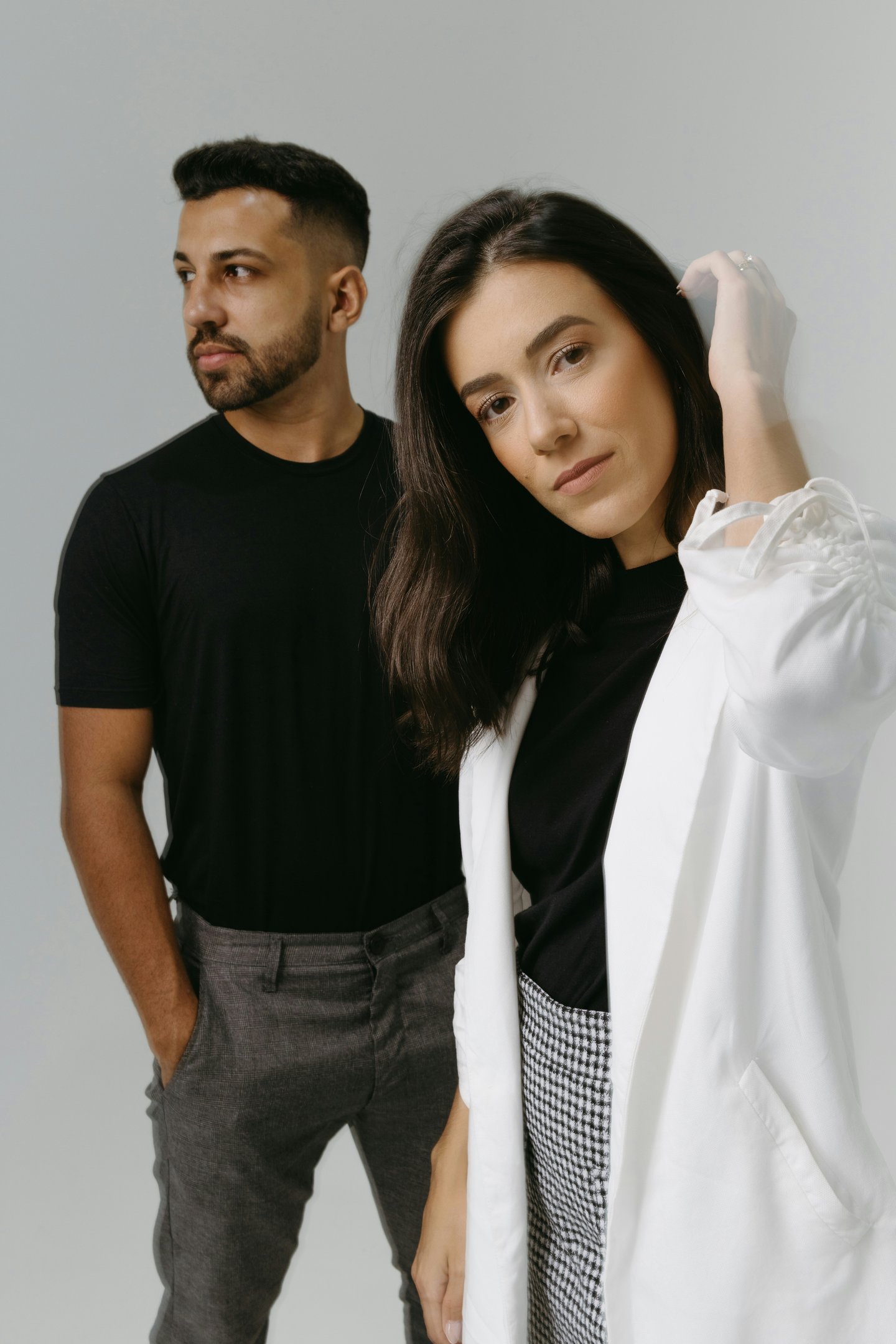 confident woman smiling looking away while man tries to get her attention