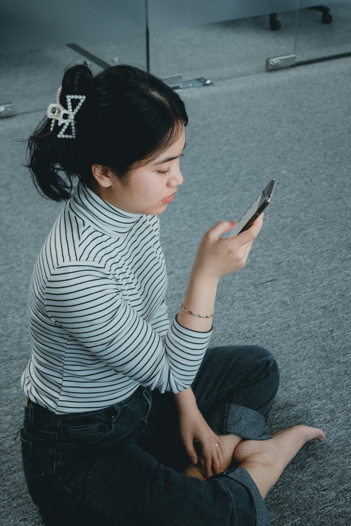 woman sitting calmly and confidently while checking her phone, not anxious