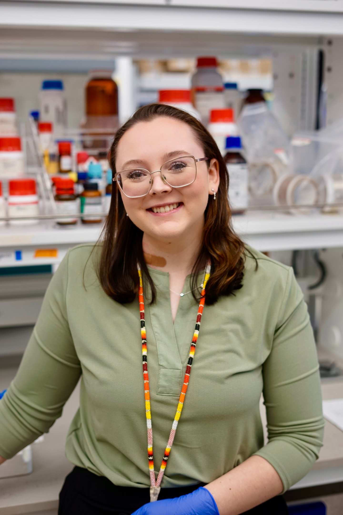 Baylie Phillips portrait photo in laboratory with bottles in the background