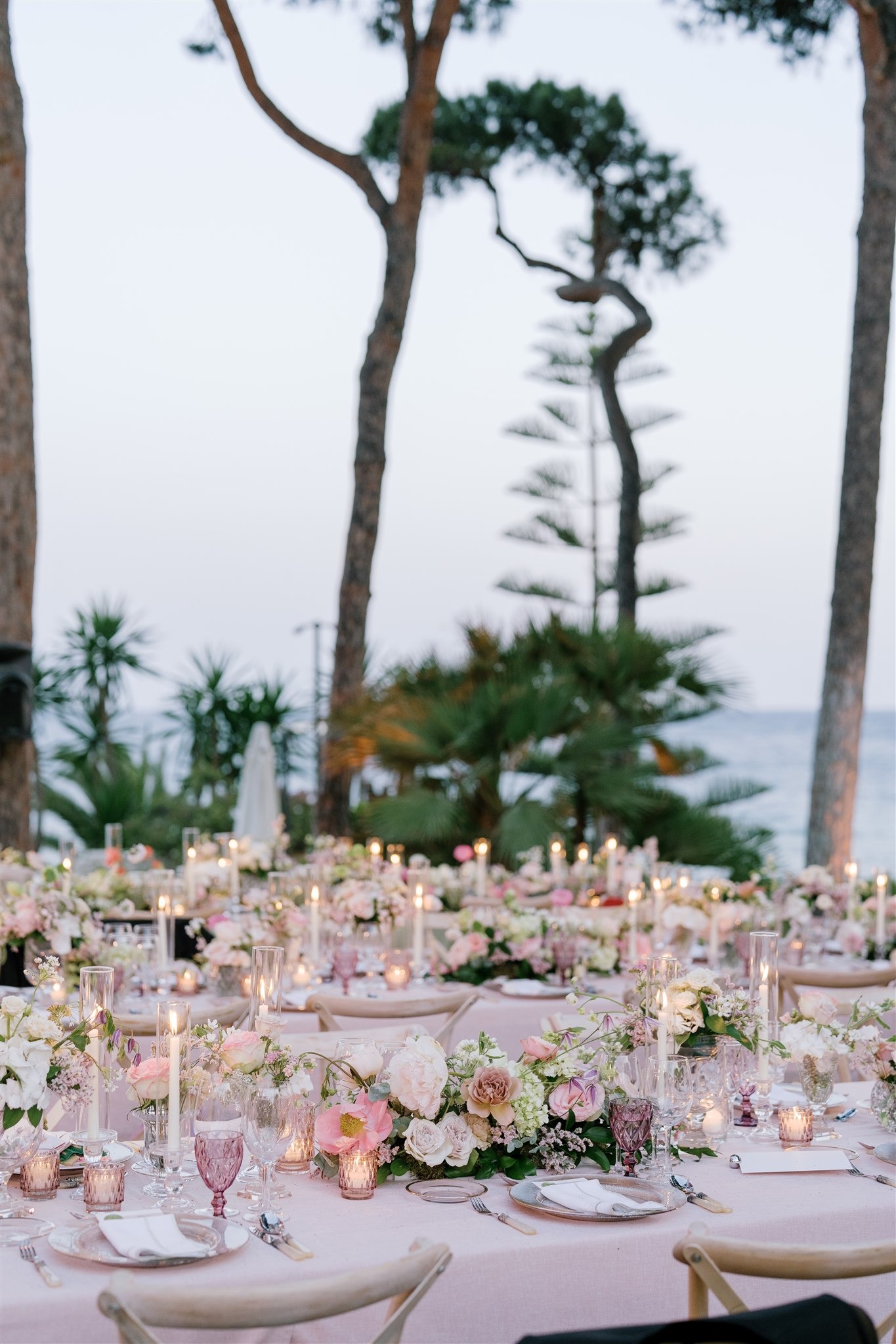 Romantic destination wedding dinner setup with floral centerpieces and candles at Villa El Rincon