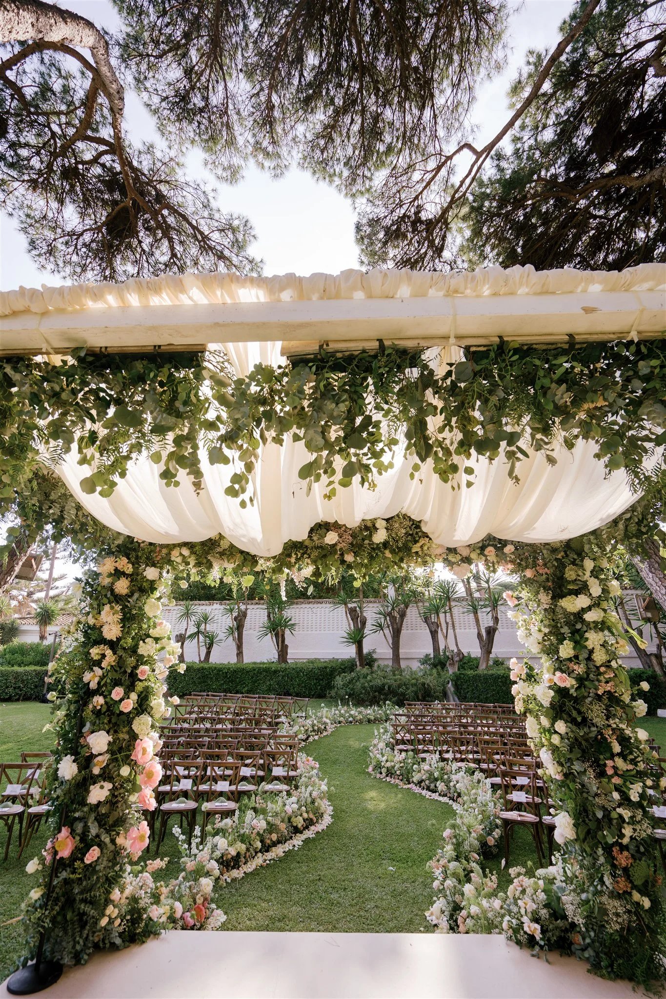 Floral wedding canopy with garden ceremony seating