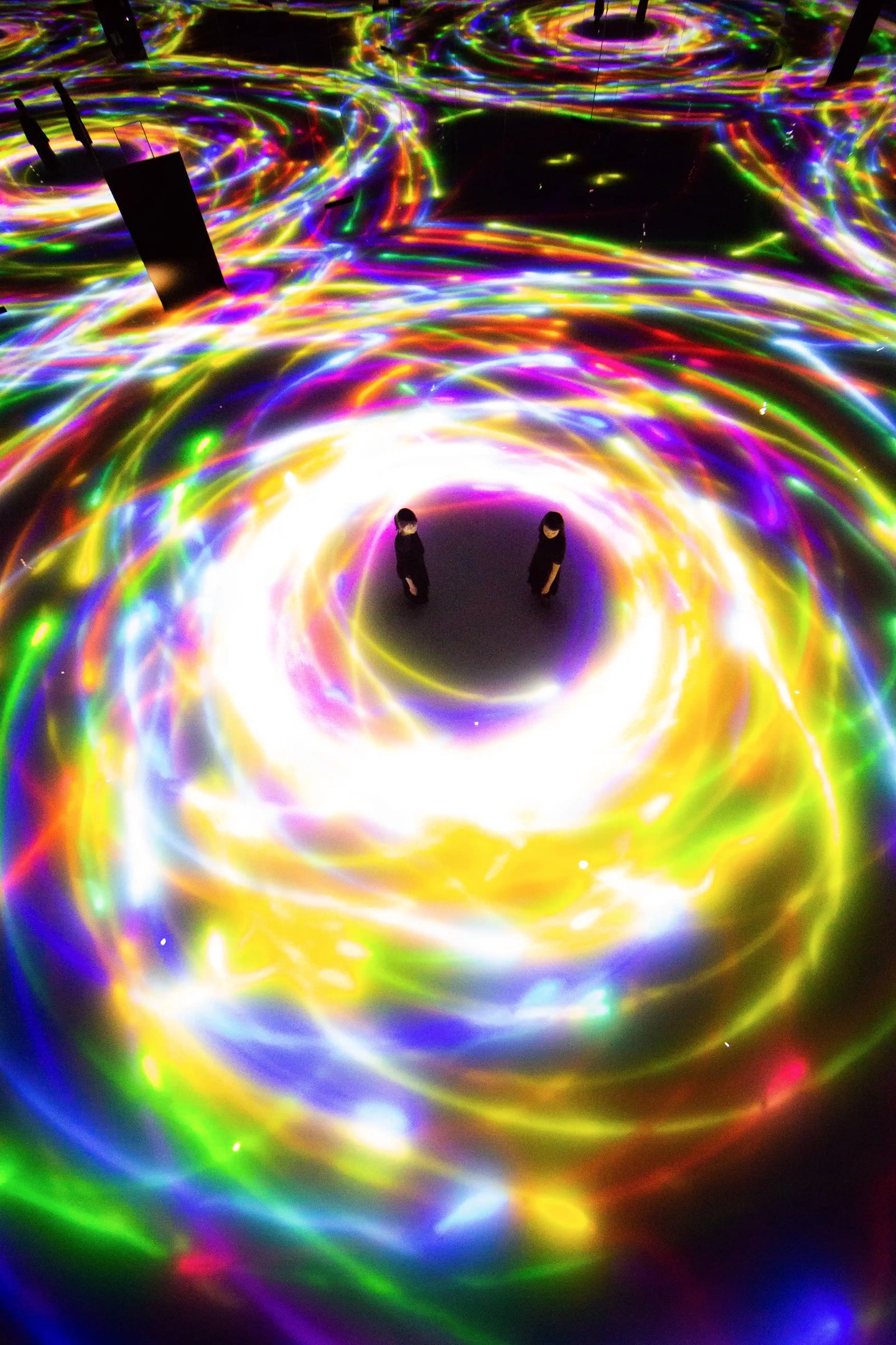 two people standing in a circle with a light that is glowing