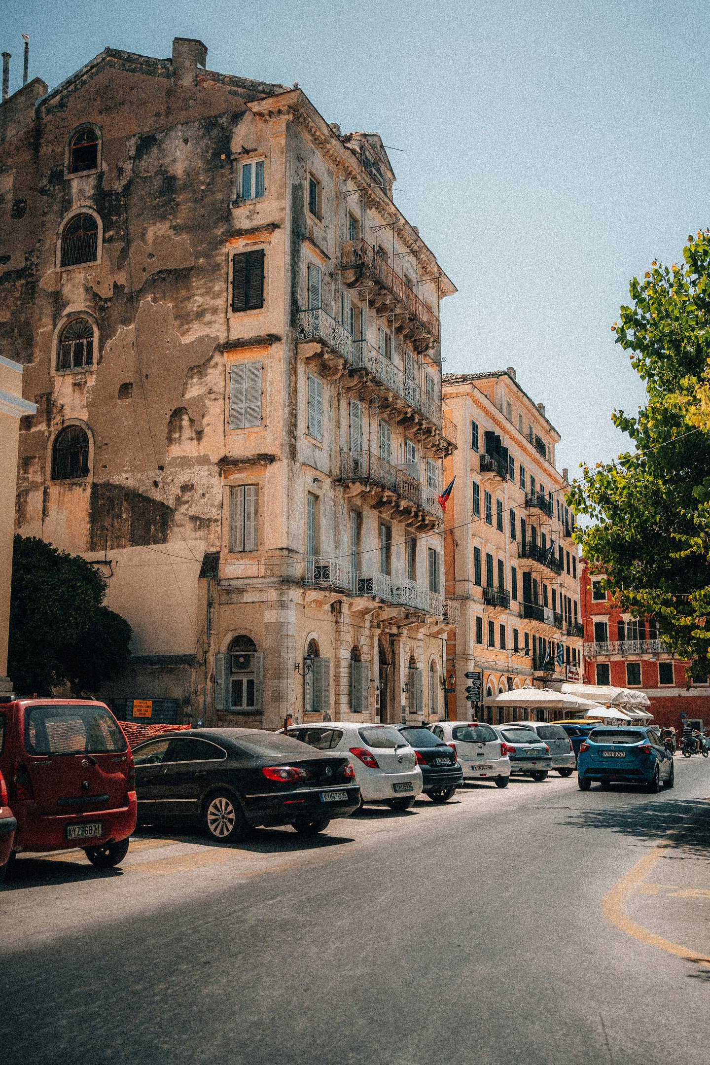 a street scene with a bus and cars parked on the side of the road