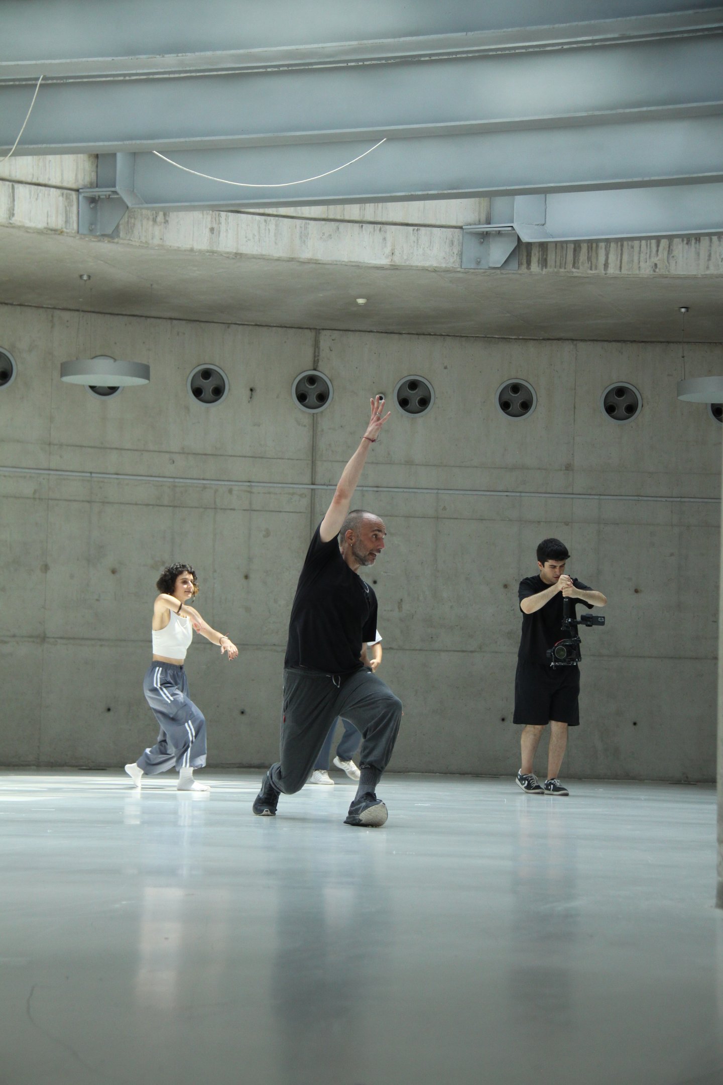 people exercising in a modern, concrete studio