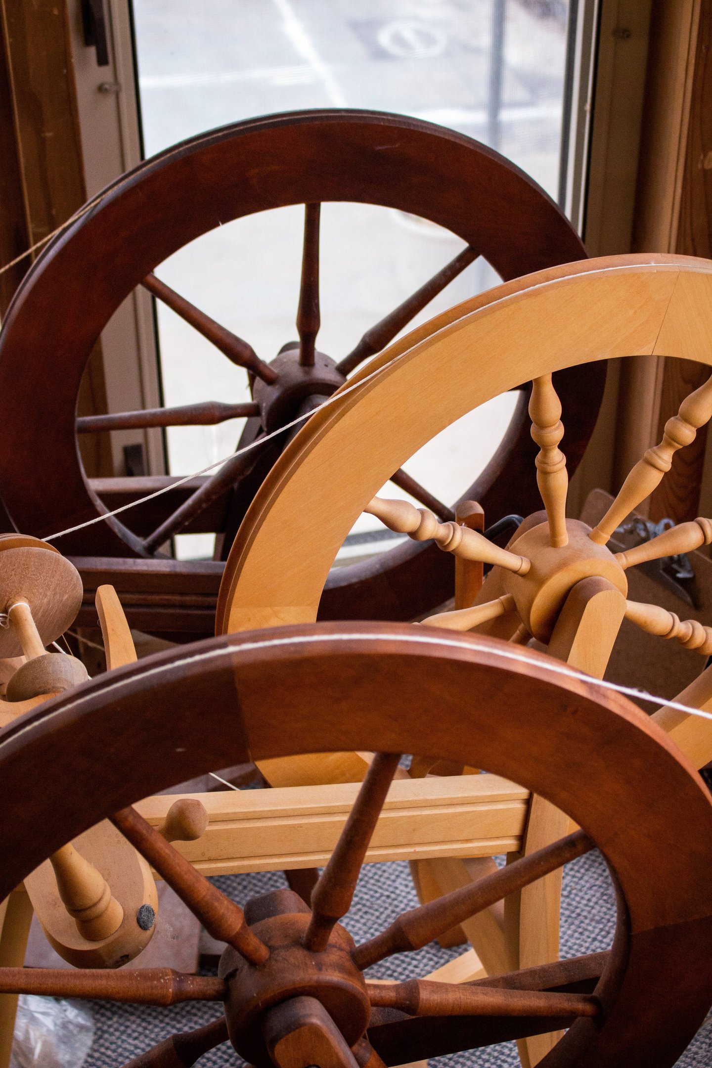 Spinning wheels lined up next to each other.