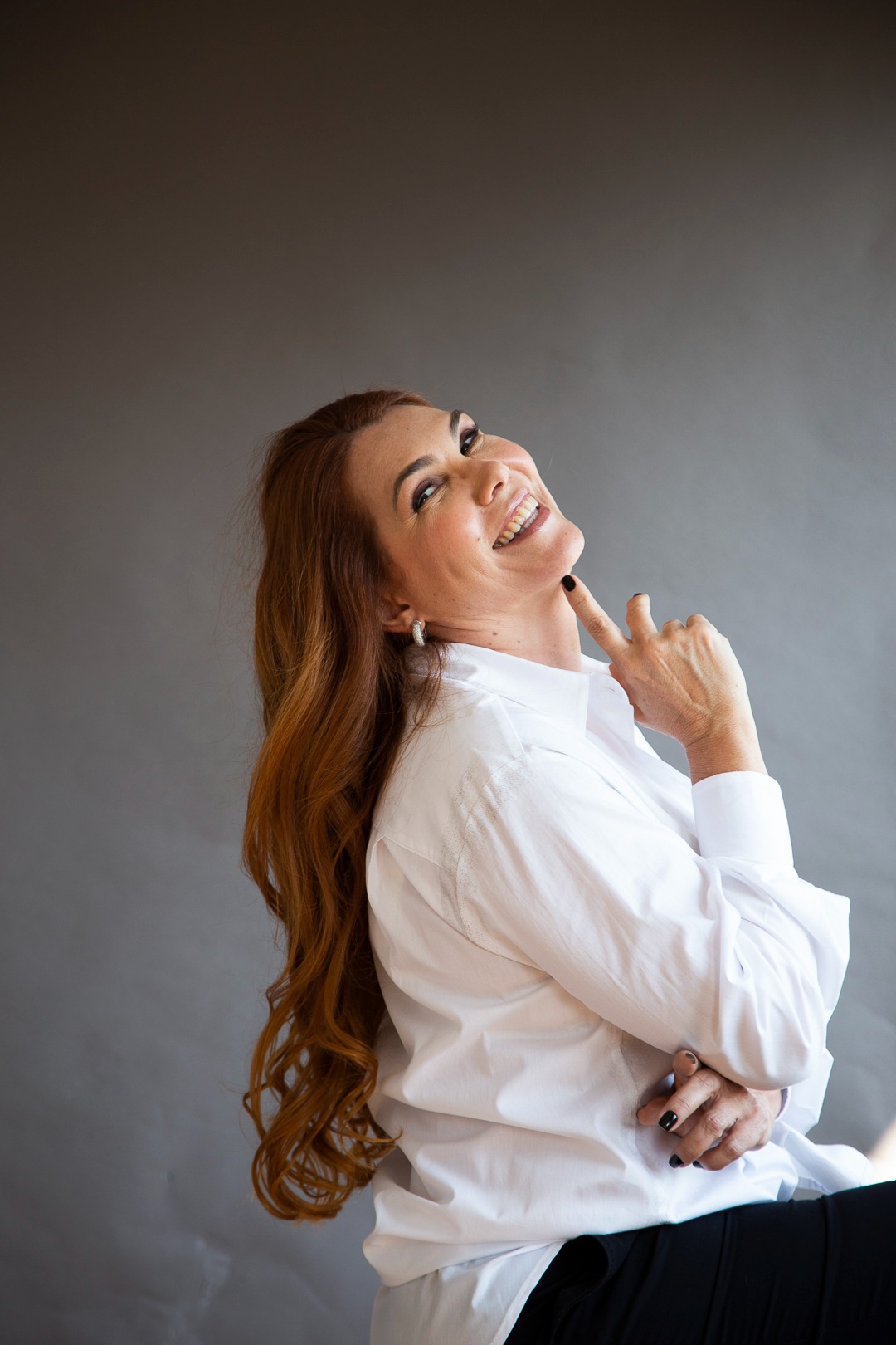a woman with long hair and a white shirt