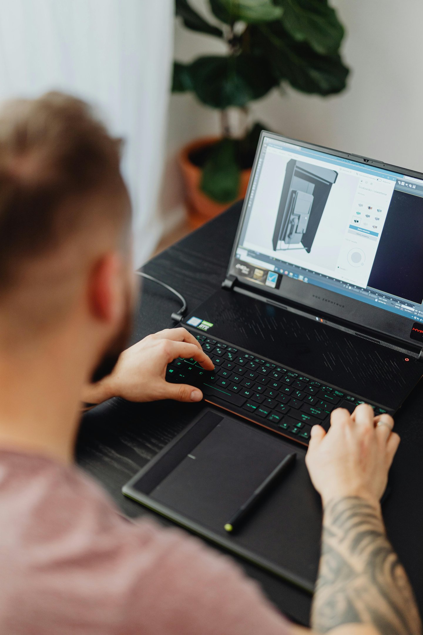 a man sitting at a desk with a laptop computer estimating a custom 3d project
