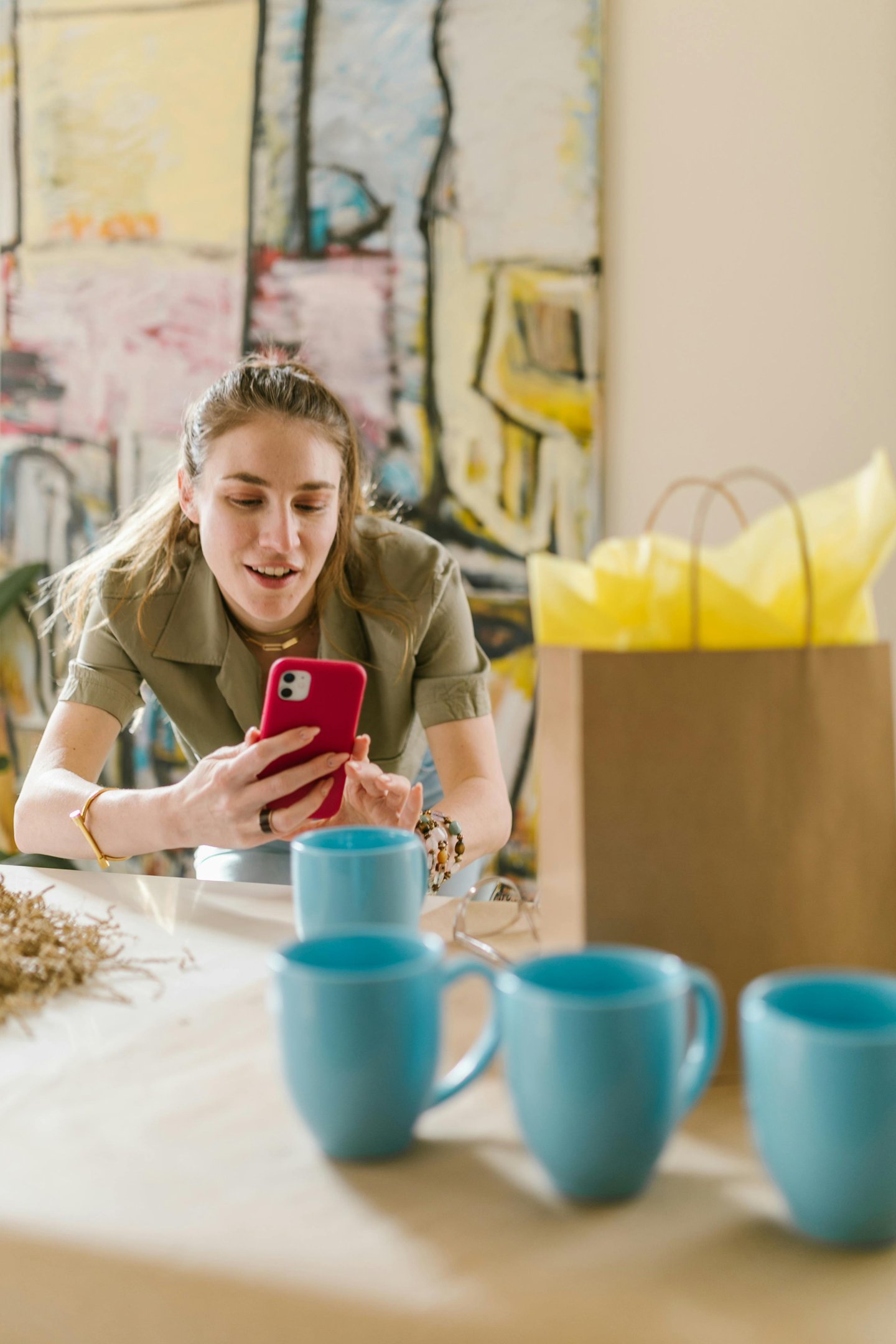 a woman sitting at a table with a phone phone
