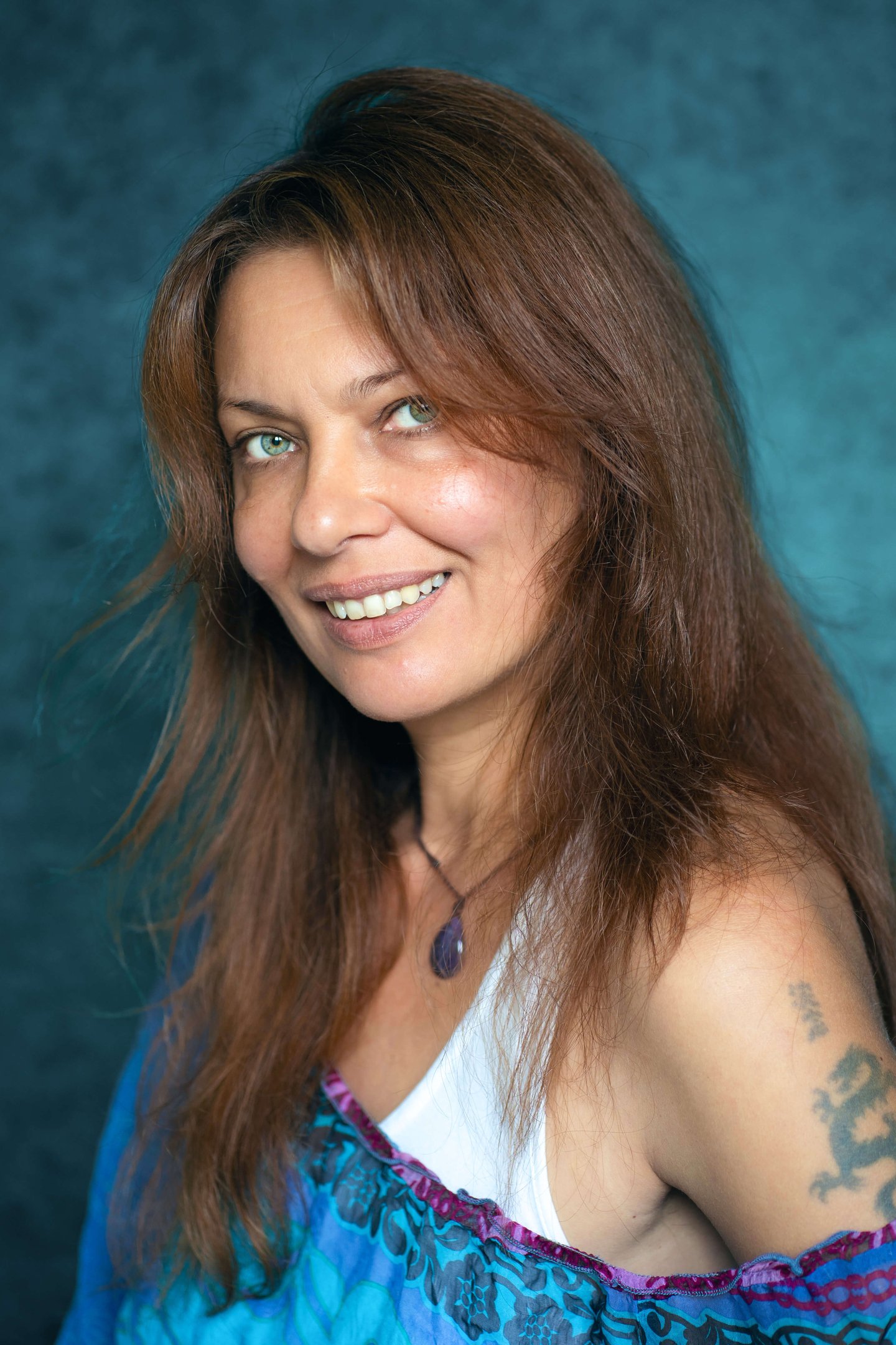 a woman with tattoos on her arm and a tattoo on her arm