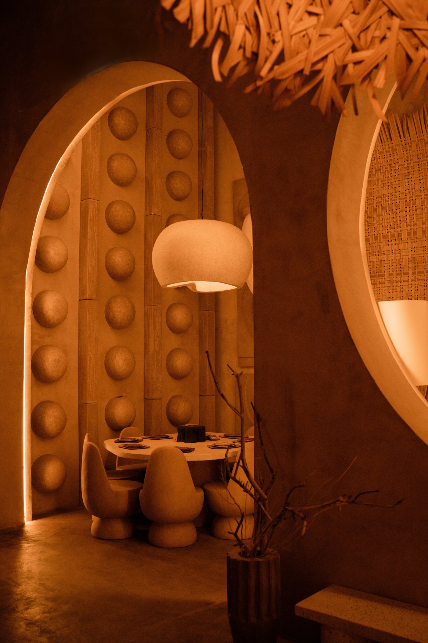 Sculptural terracotta interior niche with arched forms and warm ambient lighting