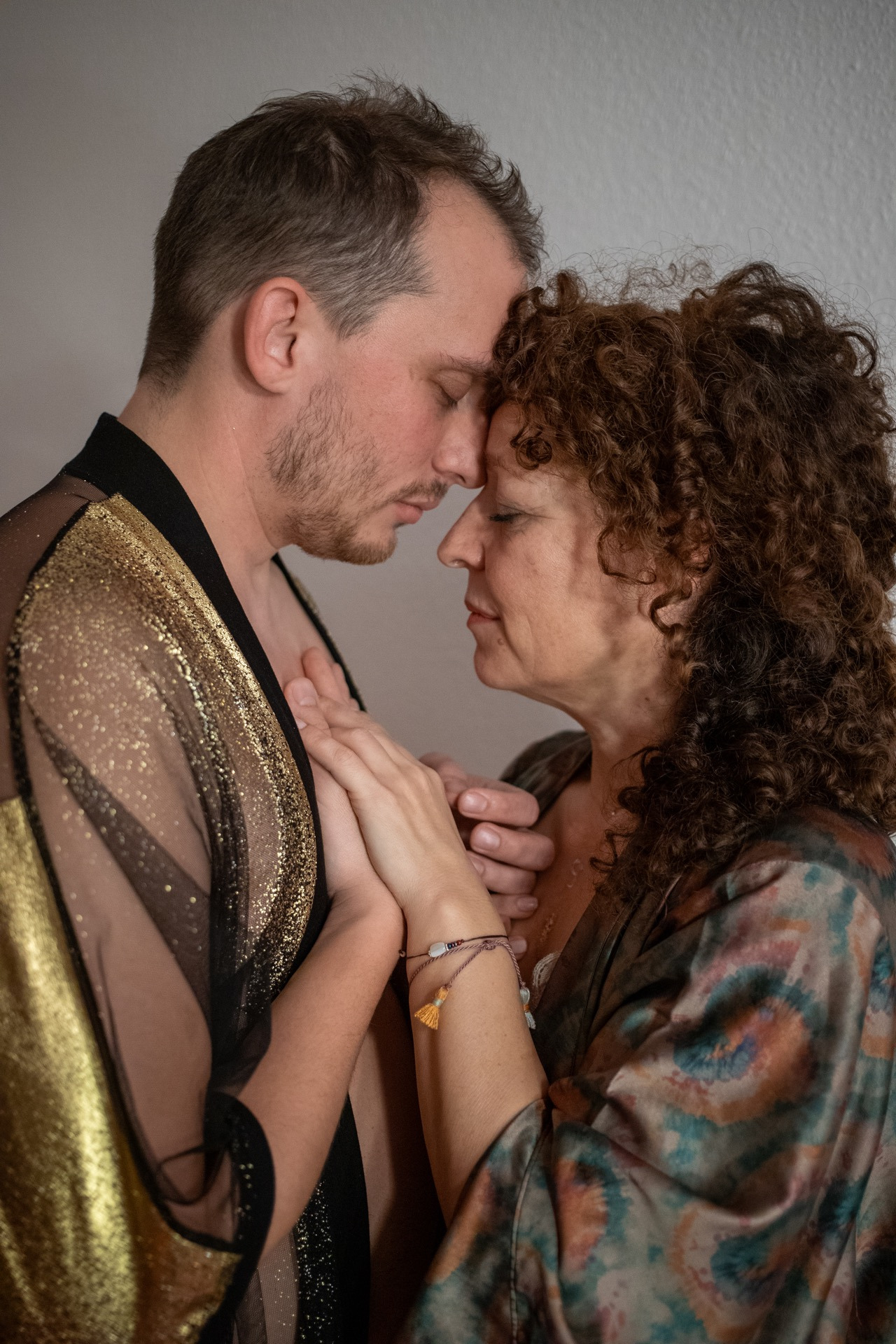 a man and woman holding hands in an embrace