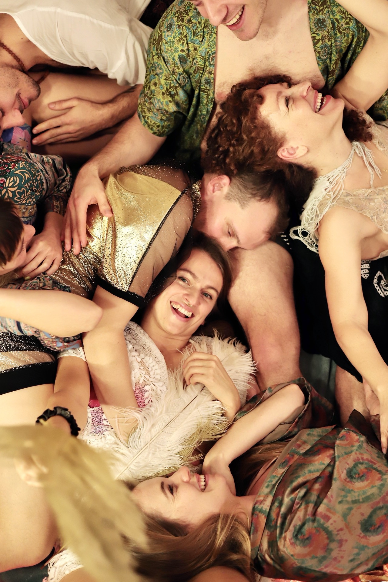 a group of people laying on the floor in a cuddle puddle