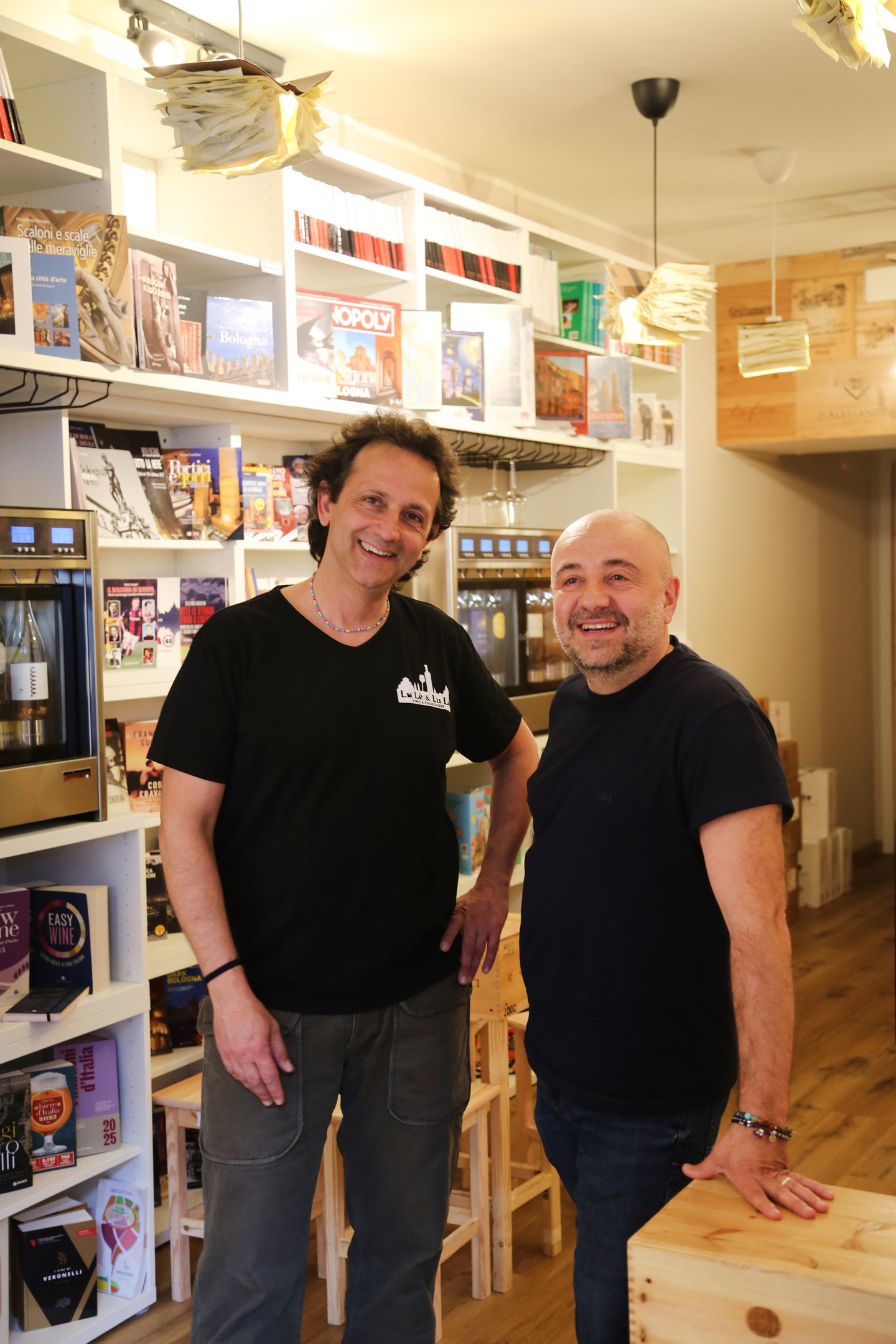 two men standing in a store with a wooden table