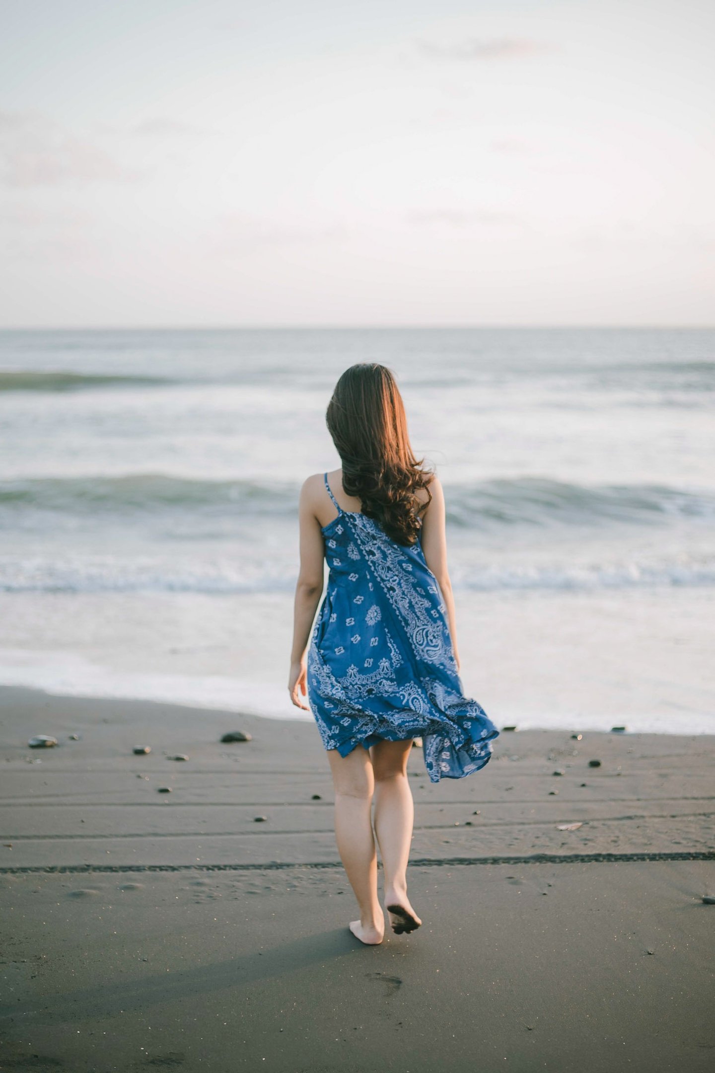 Lifestyle portrait walking along the shoreline at Pantai Nyanyi Tabanan Bali
