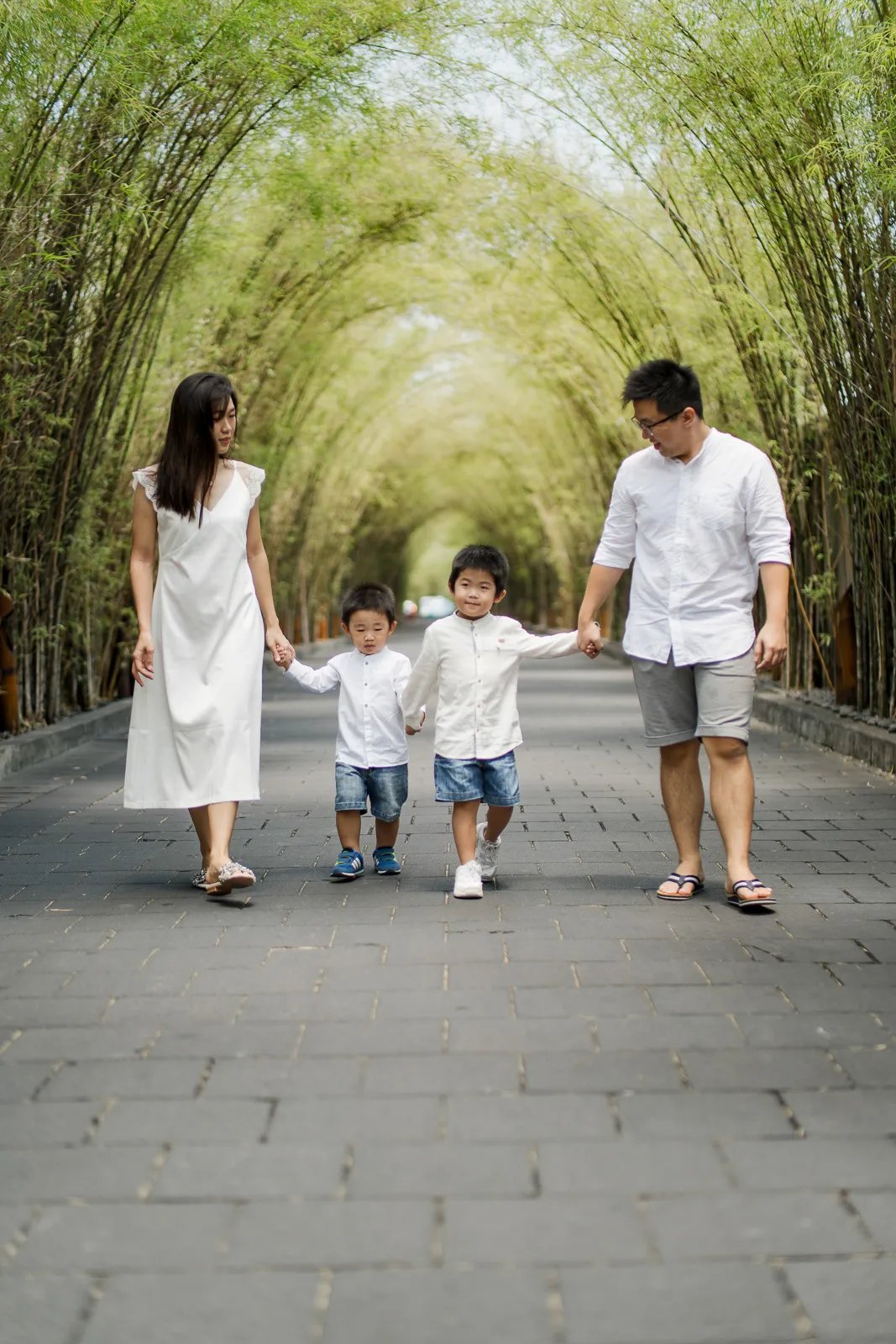 Family walking through the garden pathway during a family photography session at W Bali Seminyak