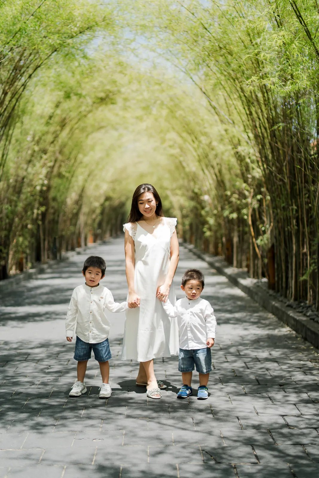 Siblings standing together during a natural family session at W Bali Seminyak