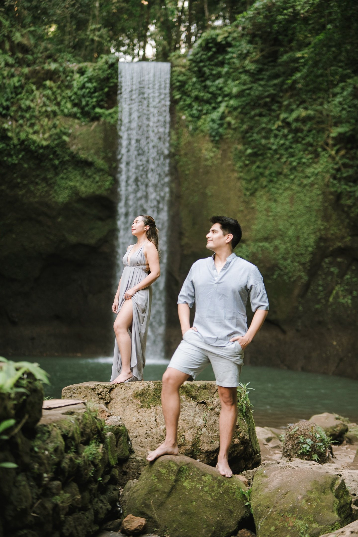 Intimate prewedding couple on rocks at Tibumana Waterfall Bangli Bali