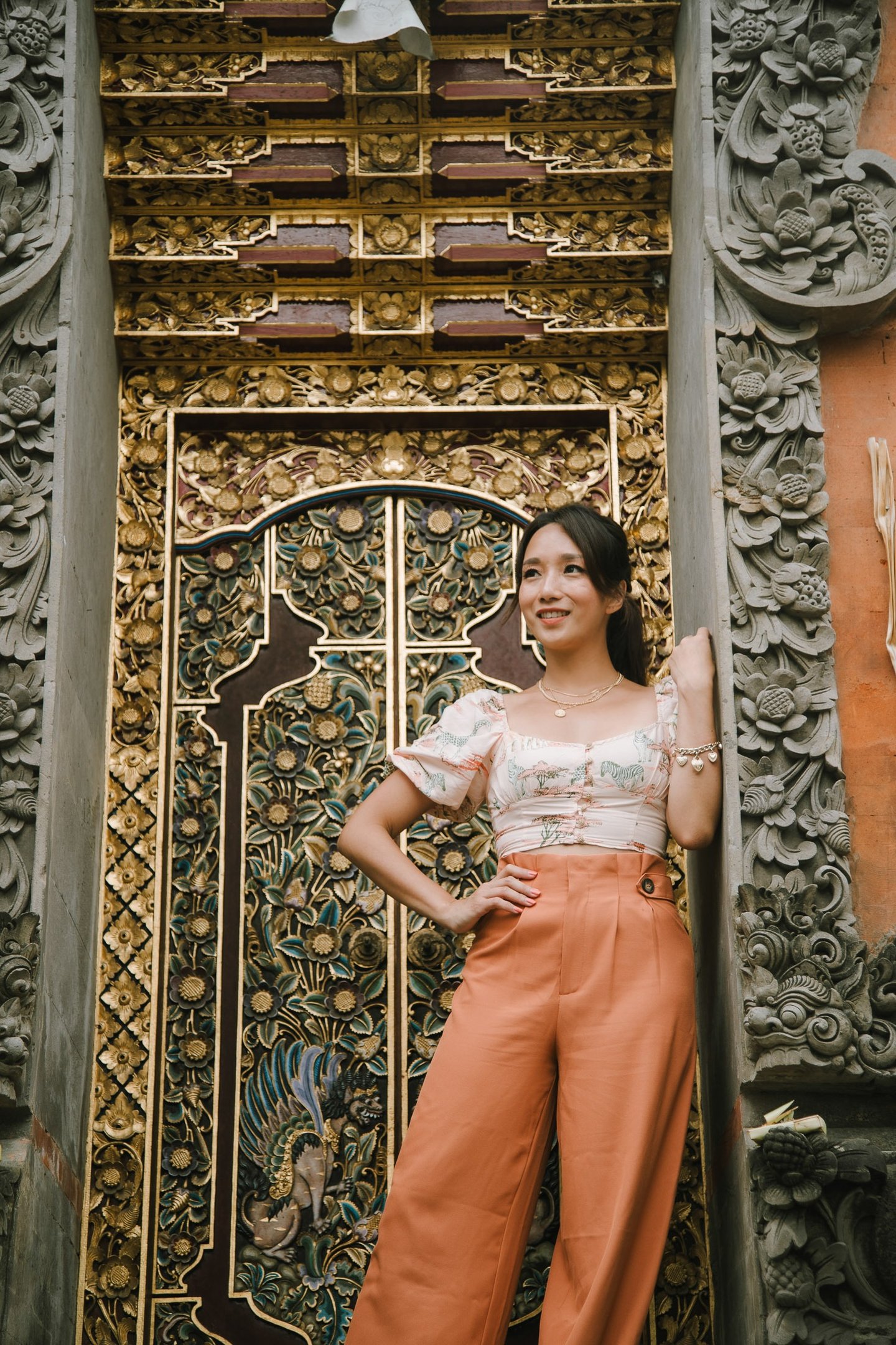 women standing in front of balinesese traditional gate