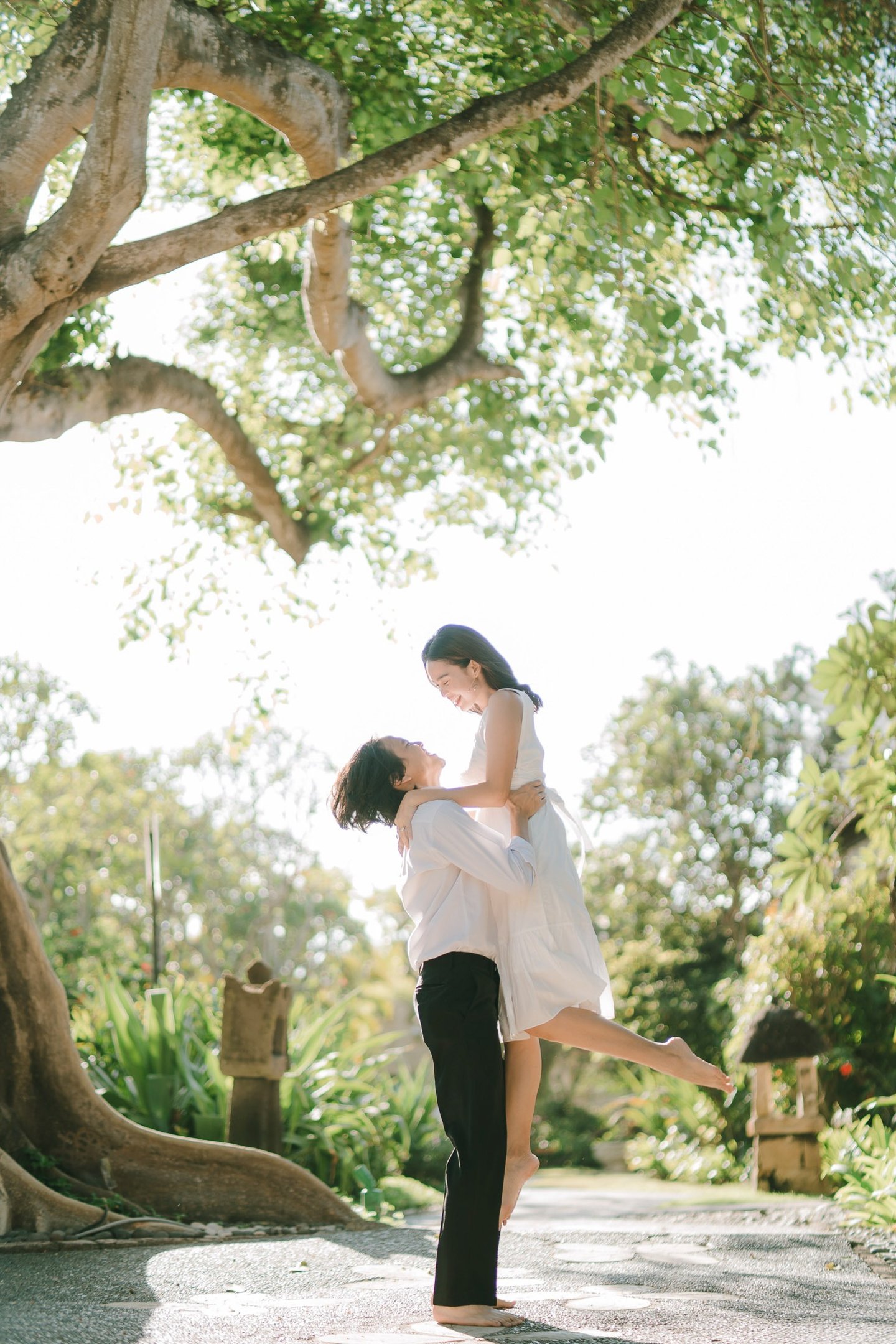 Couple portrait under a tree during an intimate photography session at Novotel Bali Benoa in Tanjung Benoa Bali.