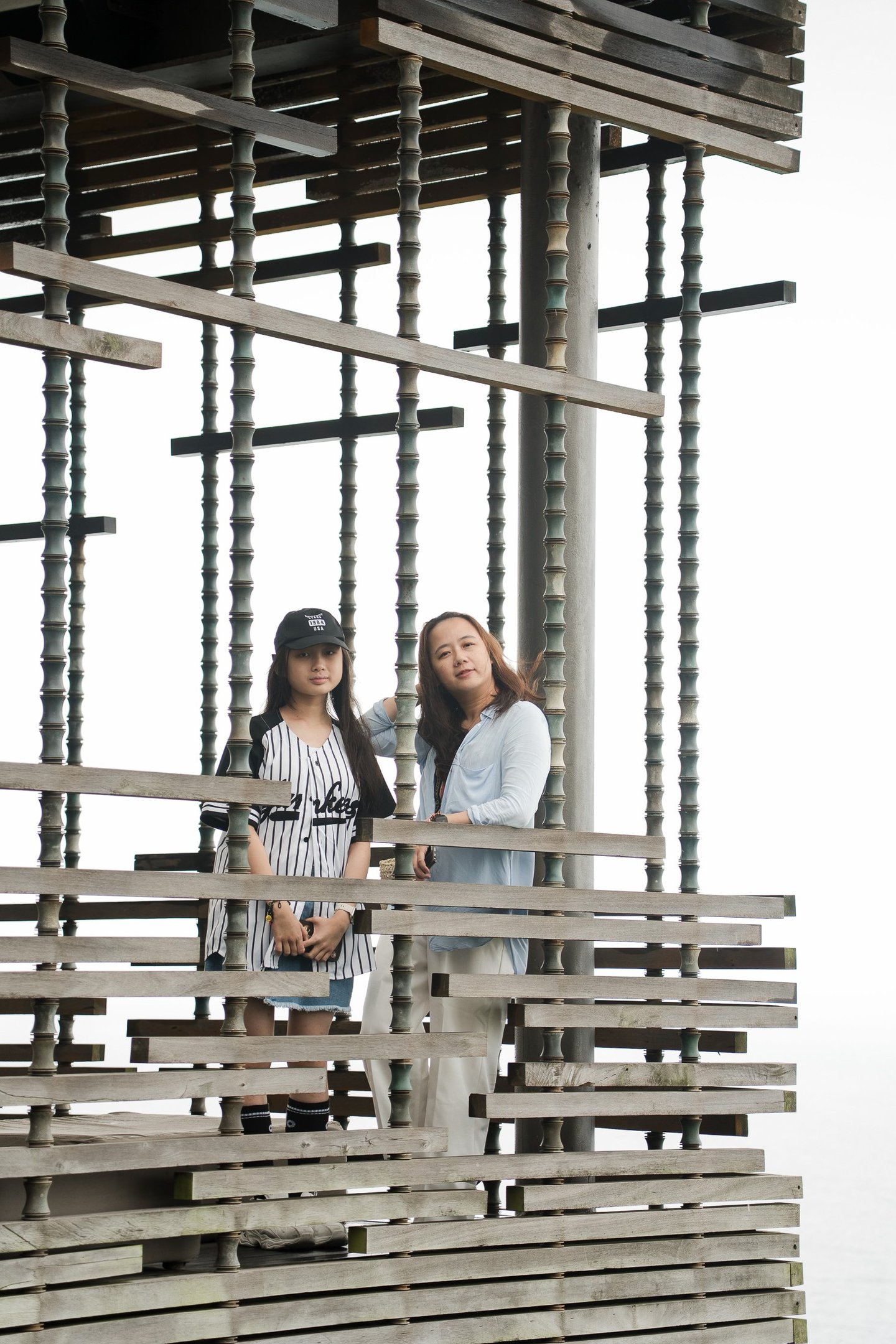 Family moment framed within architectural lines at Alila Villas Uluwatu Bali with mother and children in a calm setting