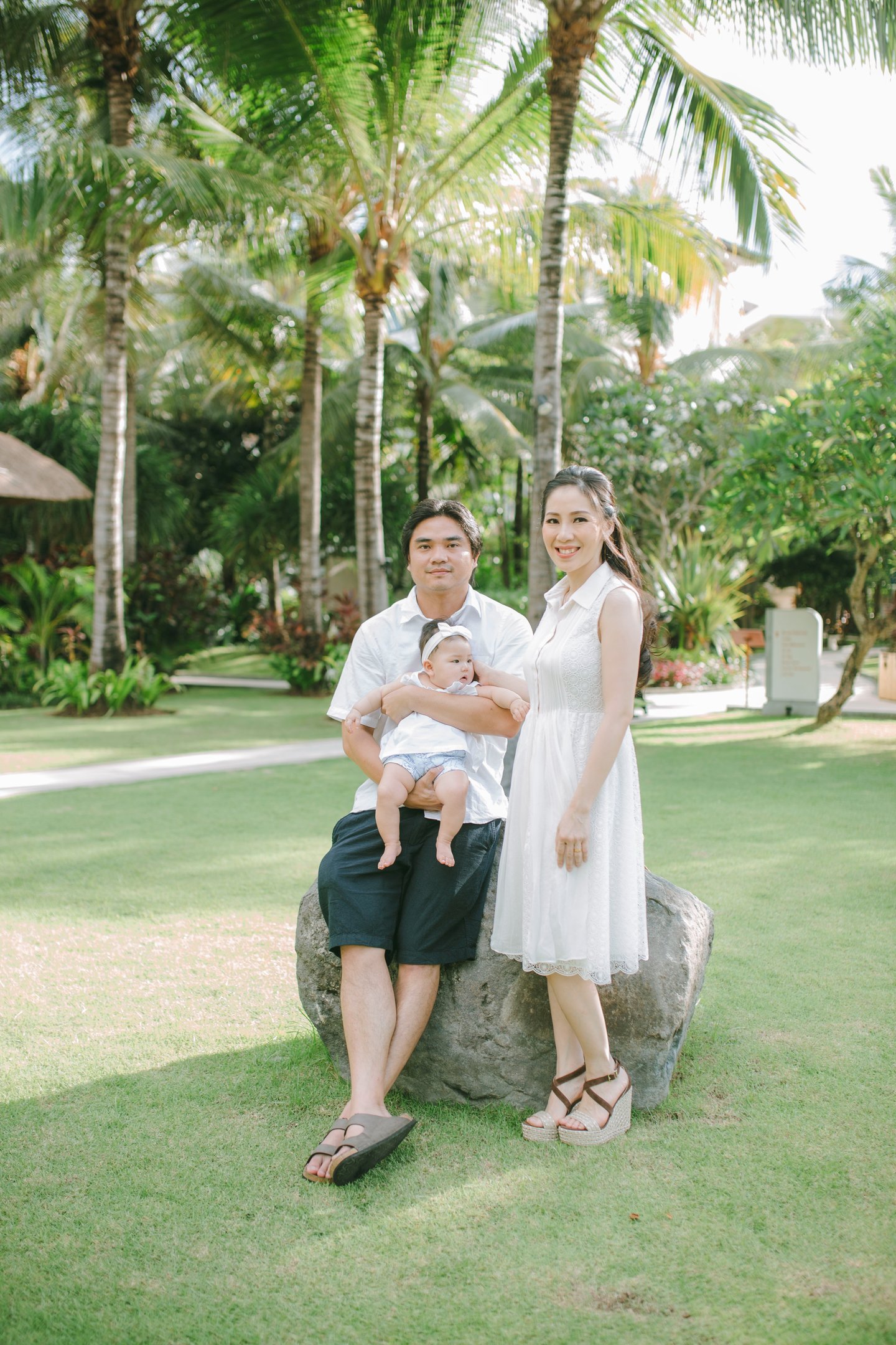 Family sitting together in garden during Sofitel Nusa Dua Bali family photography session