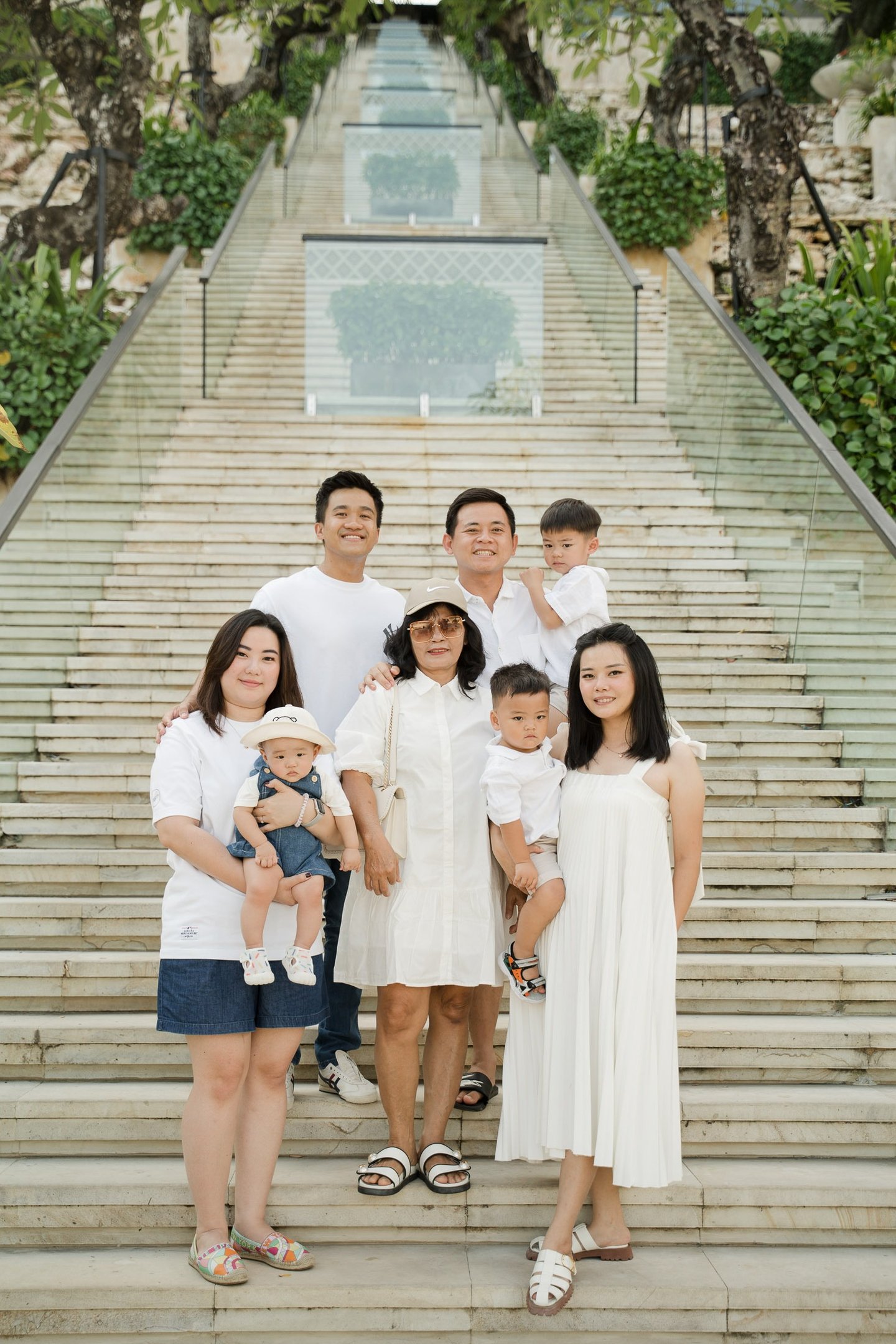 Extended family portrait on the grand staircase at The Apurva Kempinski Nusa Dua Bali