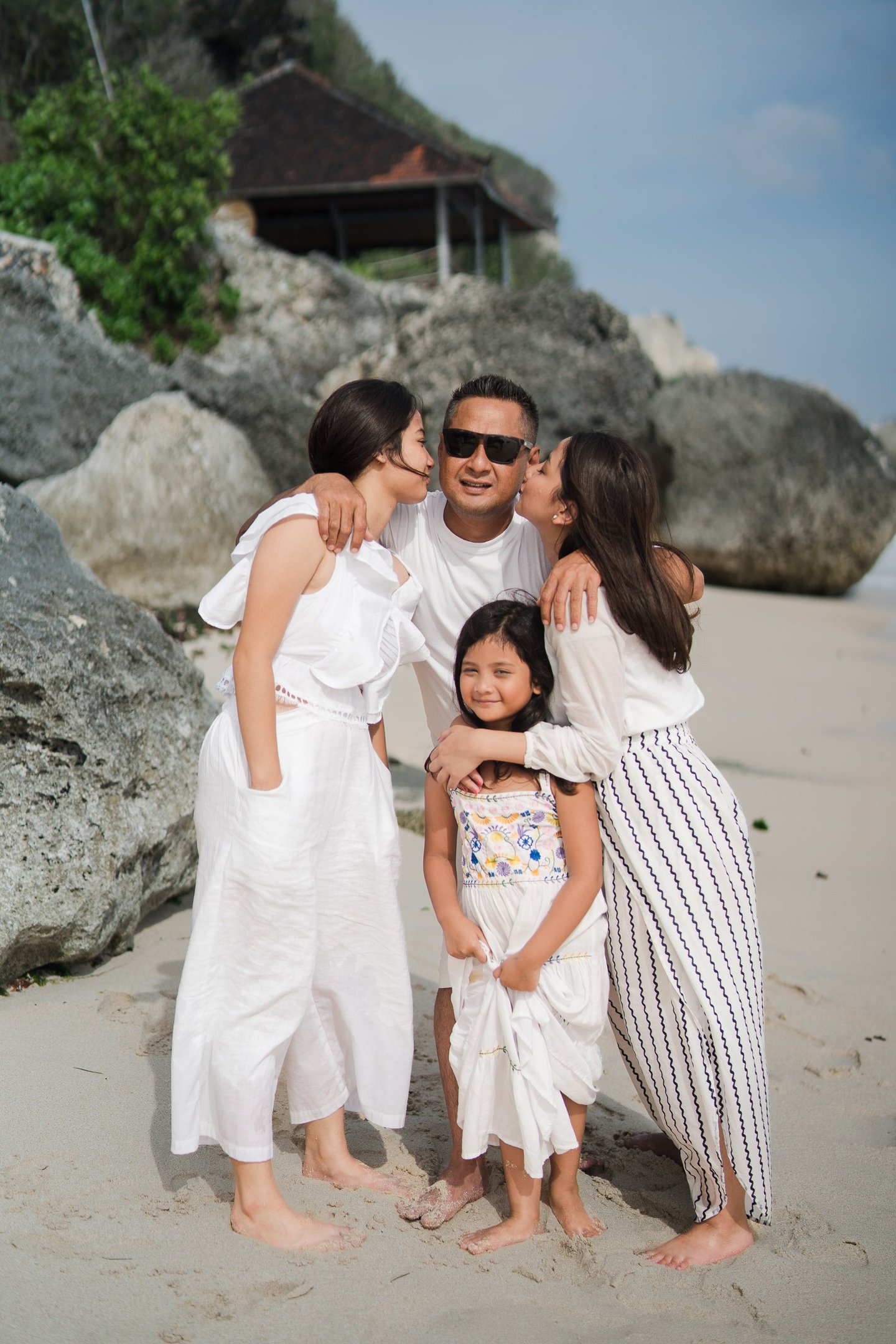 Family portrait near the rocks at Karma Kandara beach Bali  