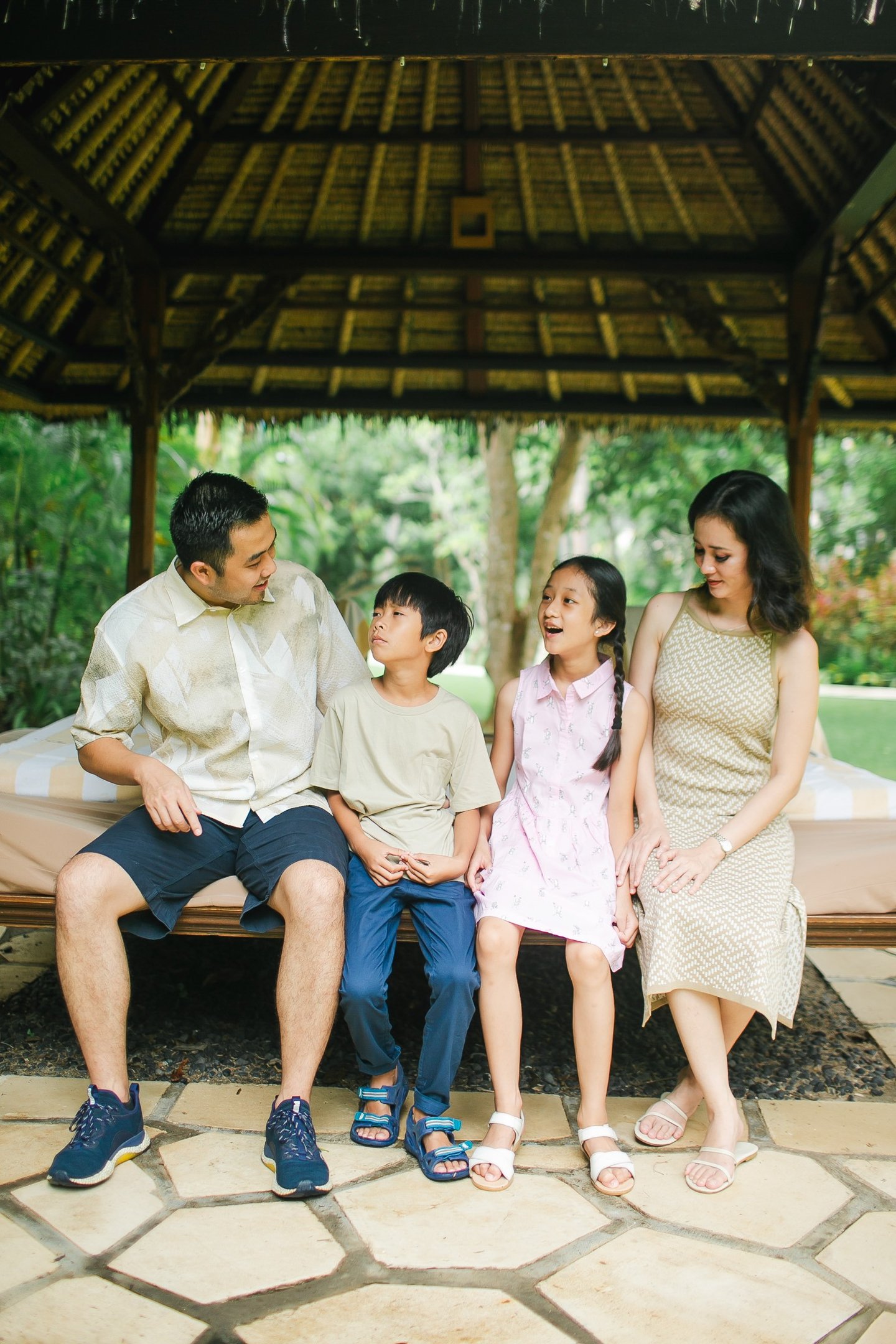 family relaxing together during photography session at Westin Nusa Dua Bali resort lounge area