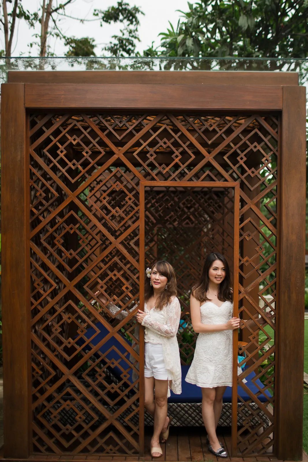 Janice family standing at the tropical villa entrance during a family photography session at Indigo Seminyak Bali