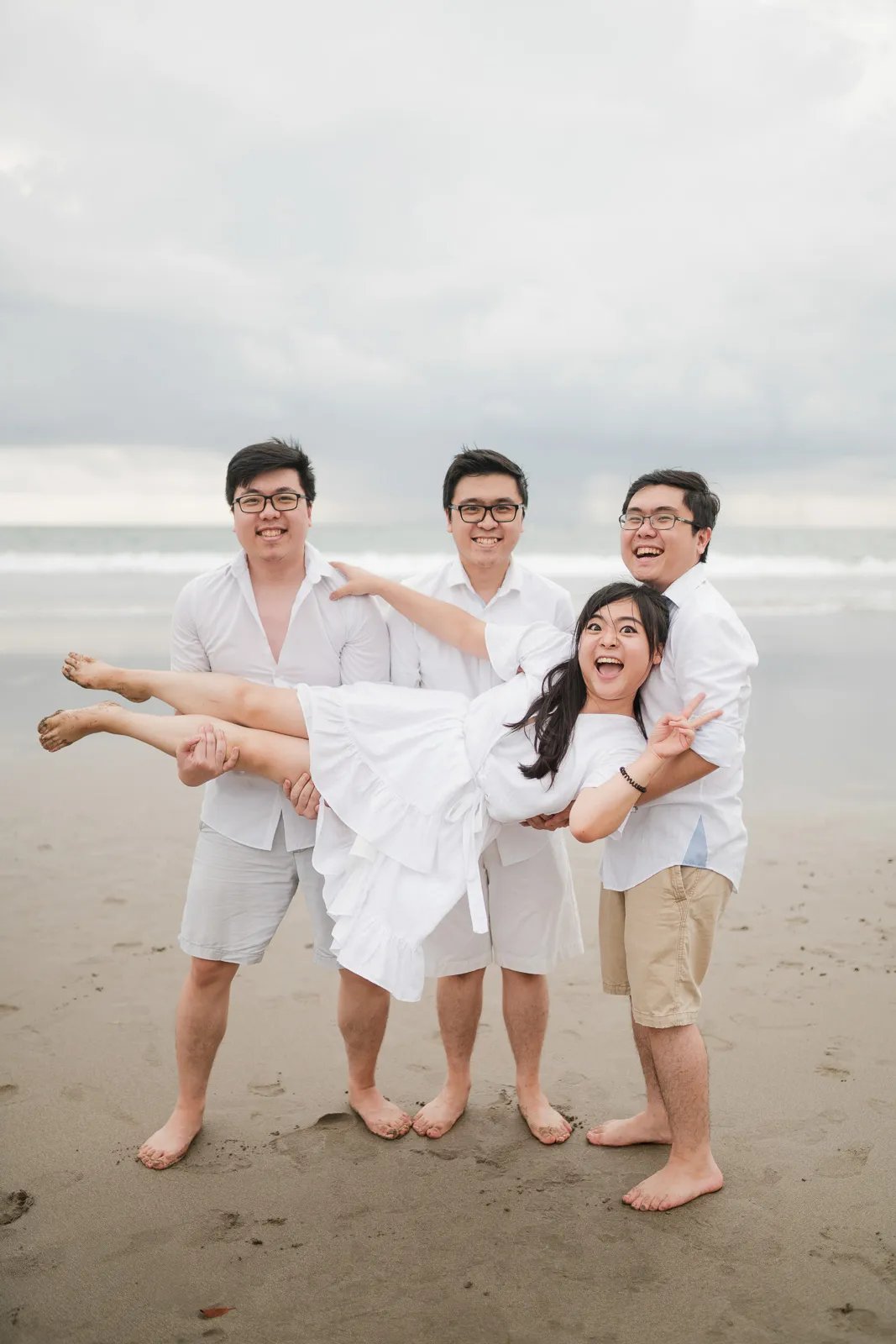 Playful multigeneration family moment at Seminyak Beach Bali captured in natural and relaxed family photography style.