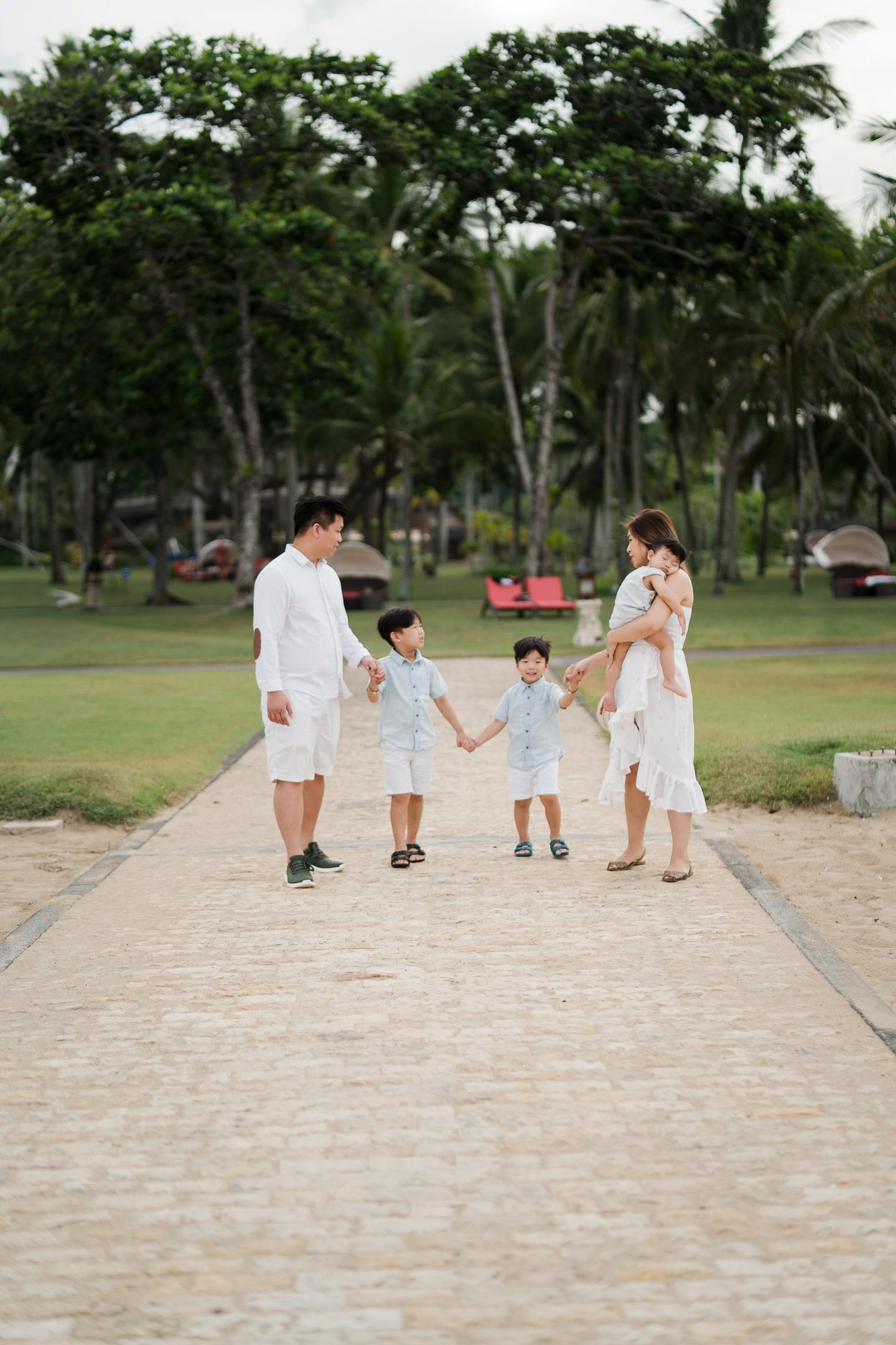 Family walking together at The Laguna Bali resort during a destination family photography session
