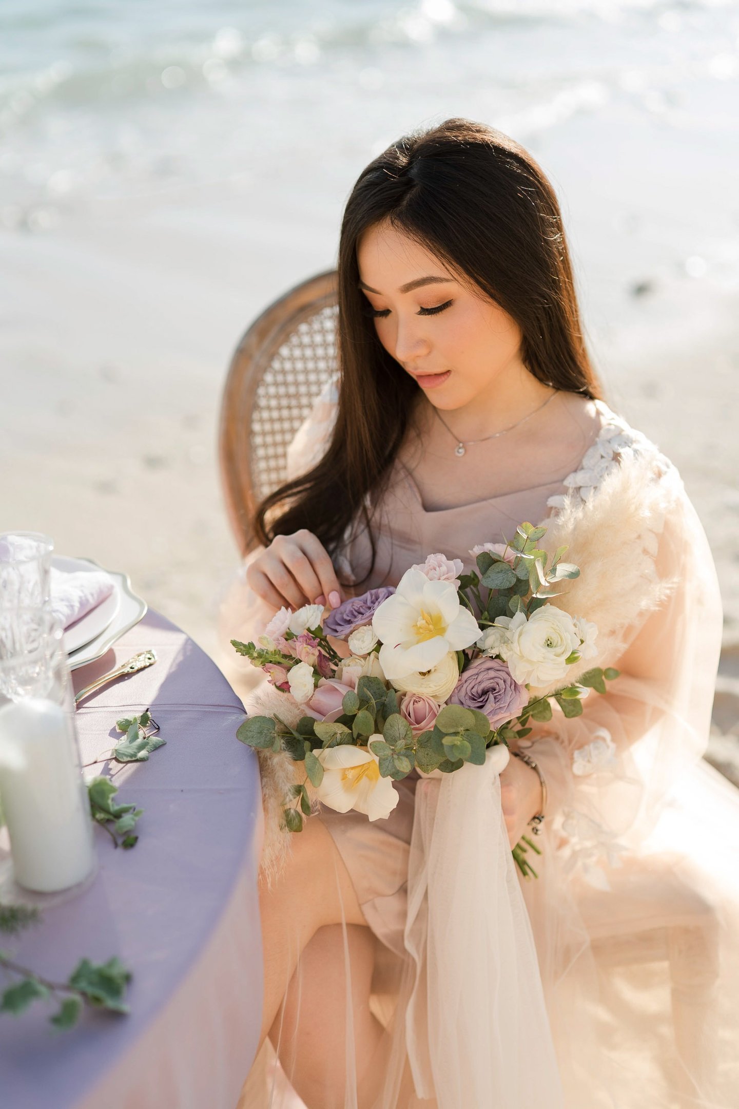 Elegant bride holding bouquet during prewedding at Melasti Beach Bali