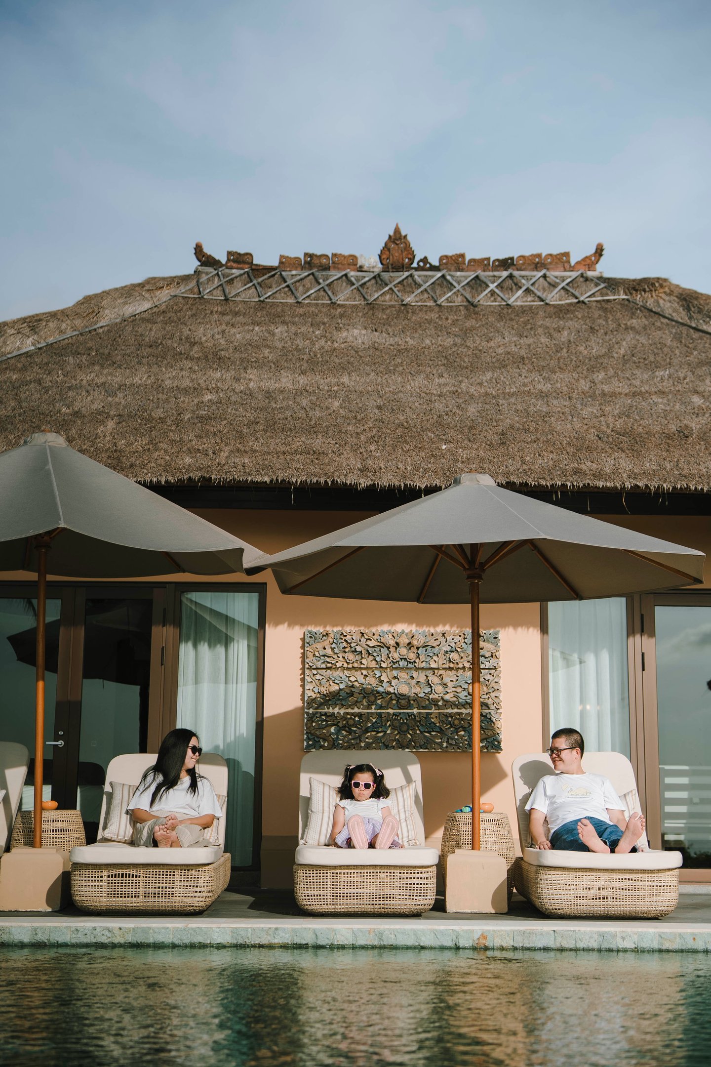 Candid family moment by the private pool at AYANA Villas Jimbaran Bali