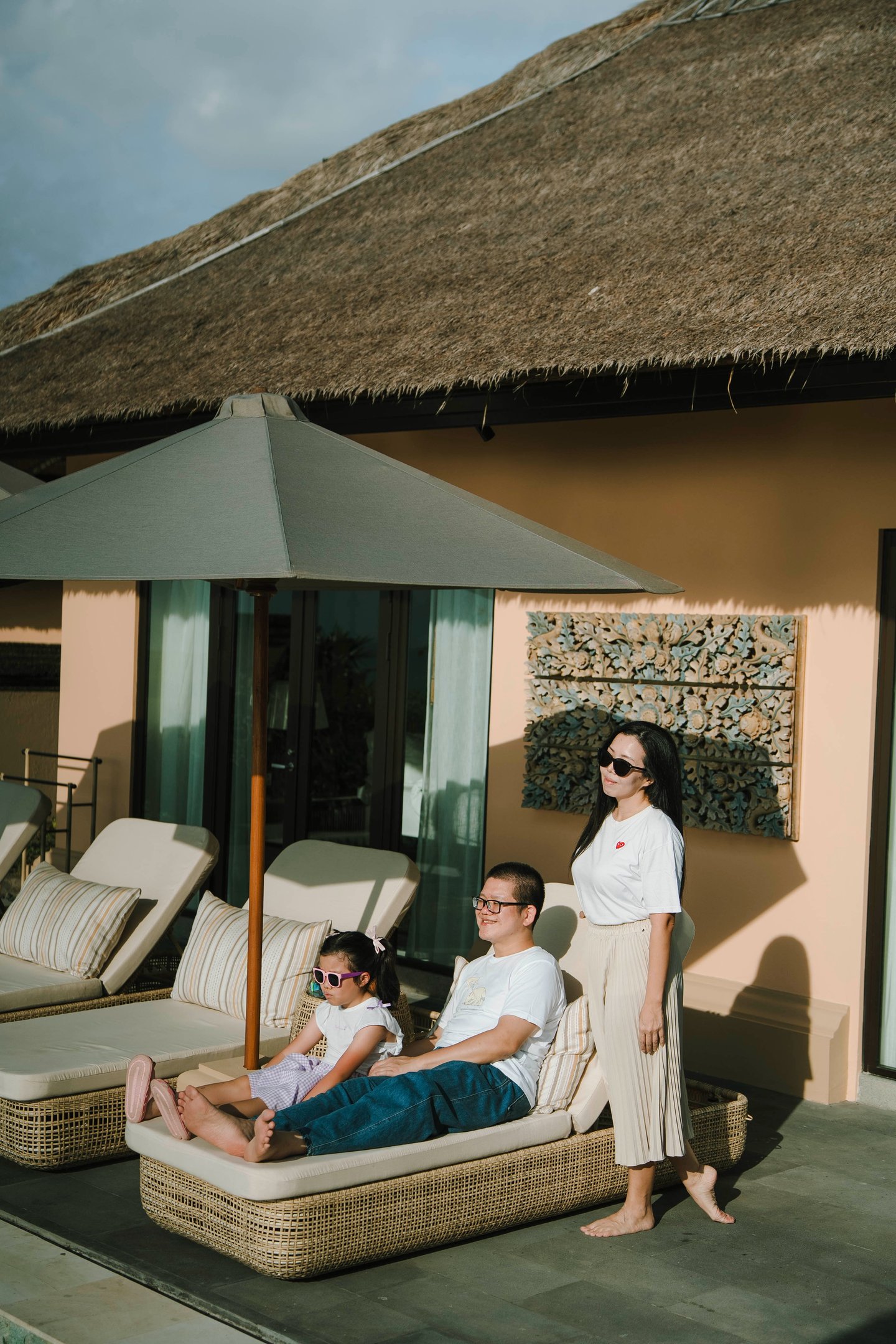 Family relaxing at private villa lounge at AYANA Villas Jimbaran – candid luxury family session in Bali