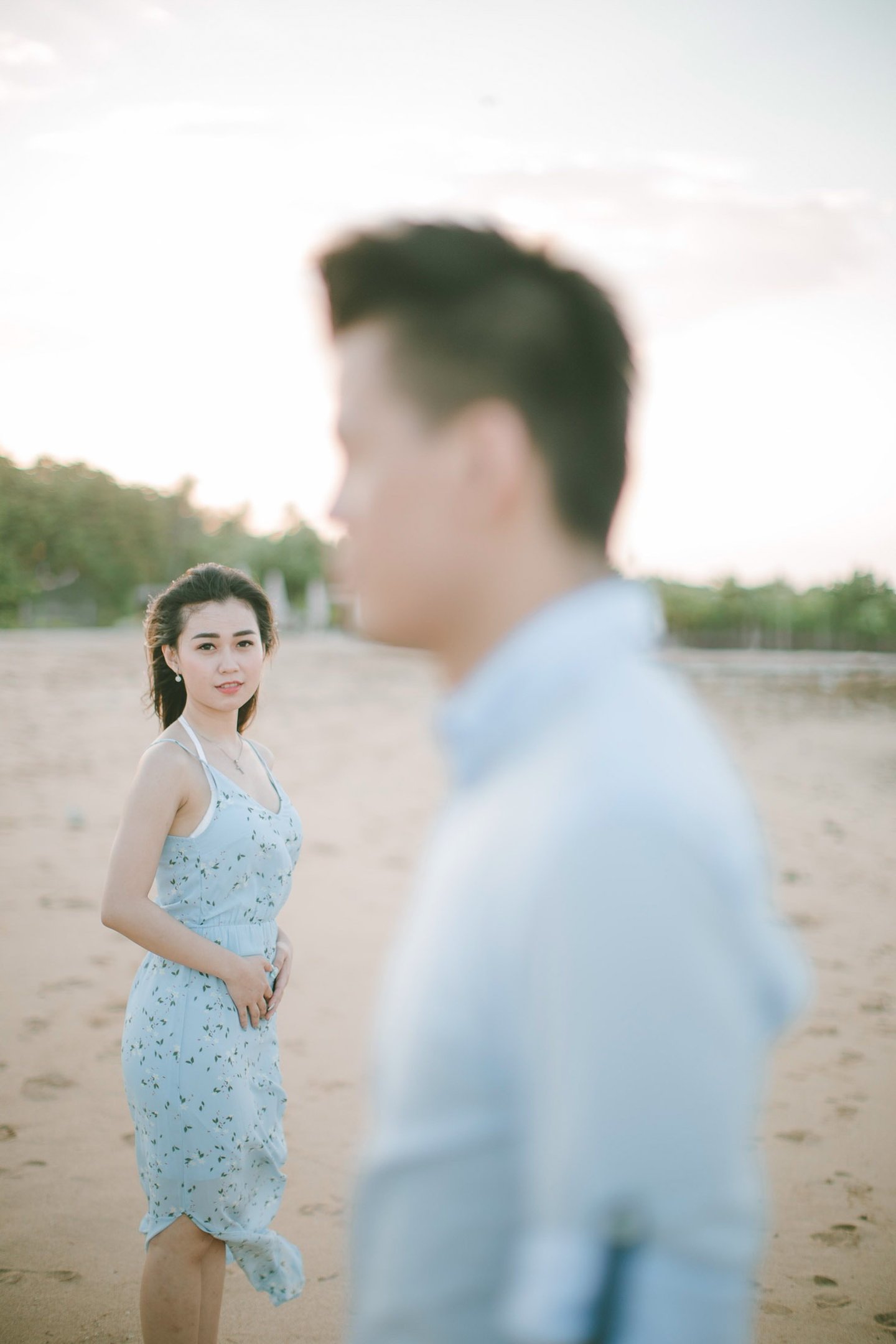Cinematic intimate couple portrait on beach at Sofitel Bali Nusa Dua Beach Resort.